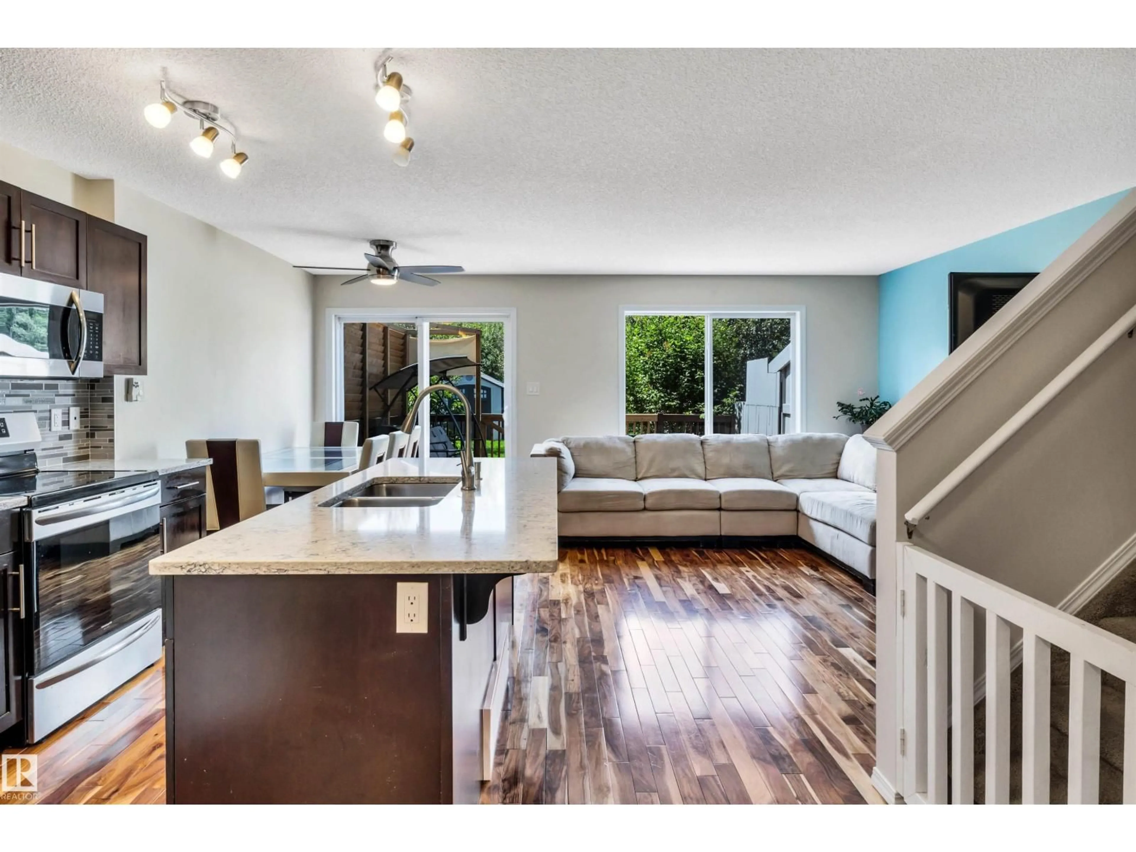 Open concept kitchen, wood/laminate floor for NW - 6012 214 ST, Edmonton Alberta T6M0H8