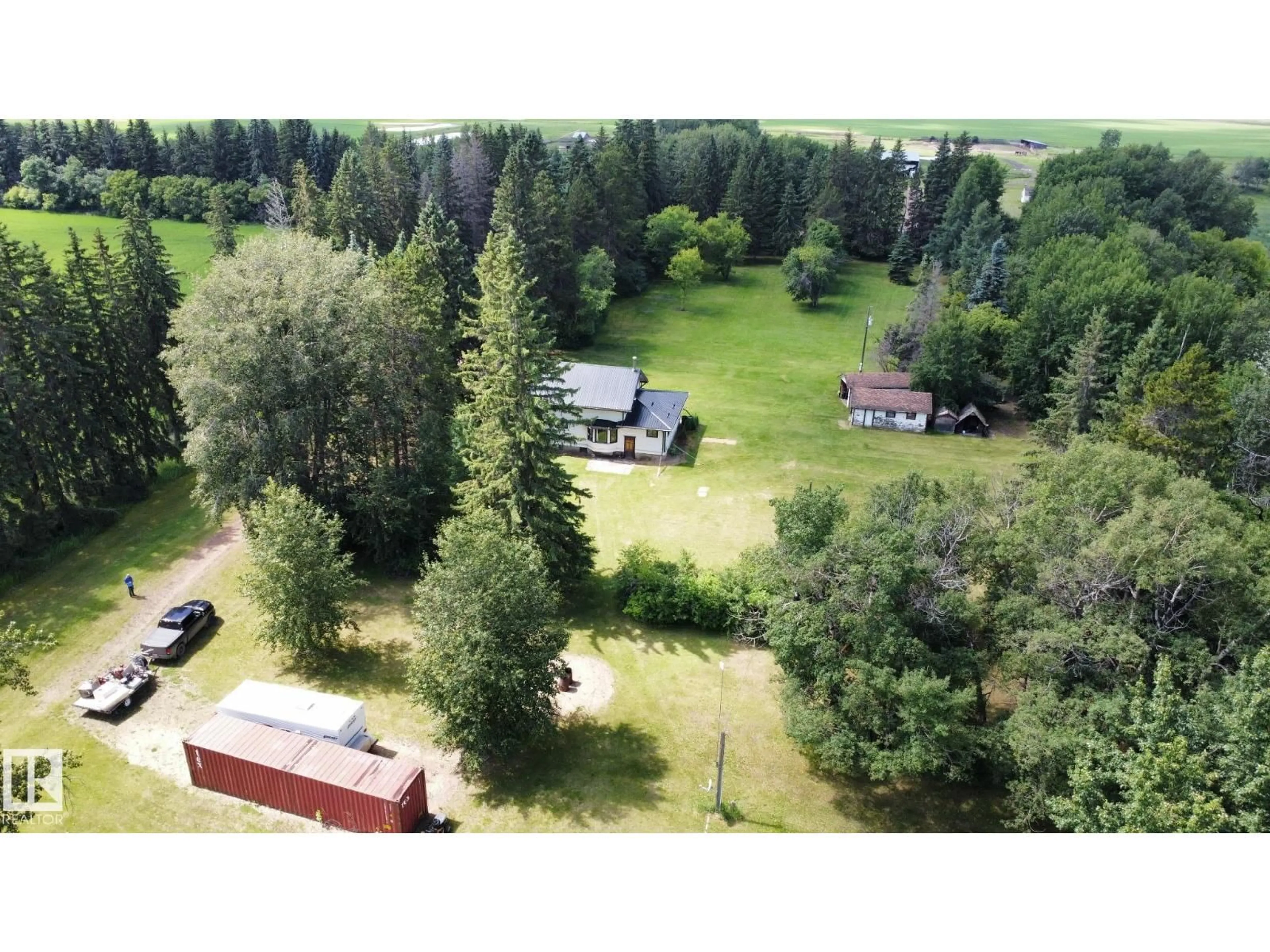A pic from outside/outdoor area/front of a property/back of a property/a pic from drone, forest/trees view for 60417 RR 10, Rural Westlock County Alberta T7P2N9