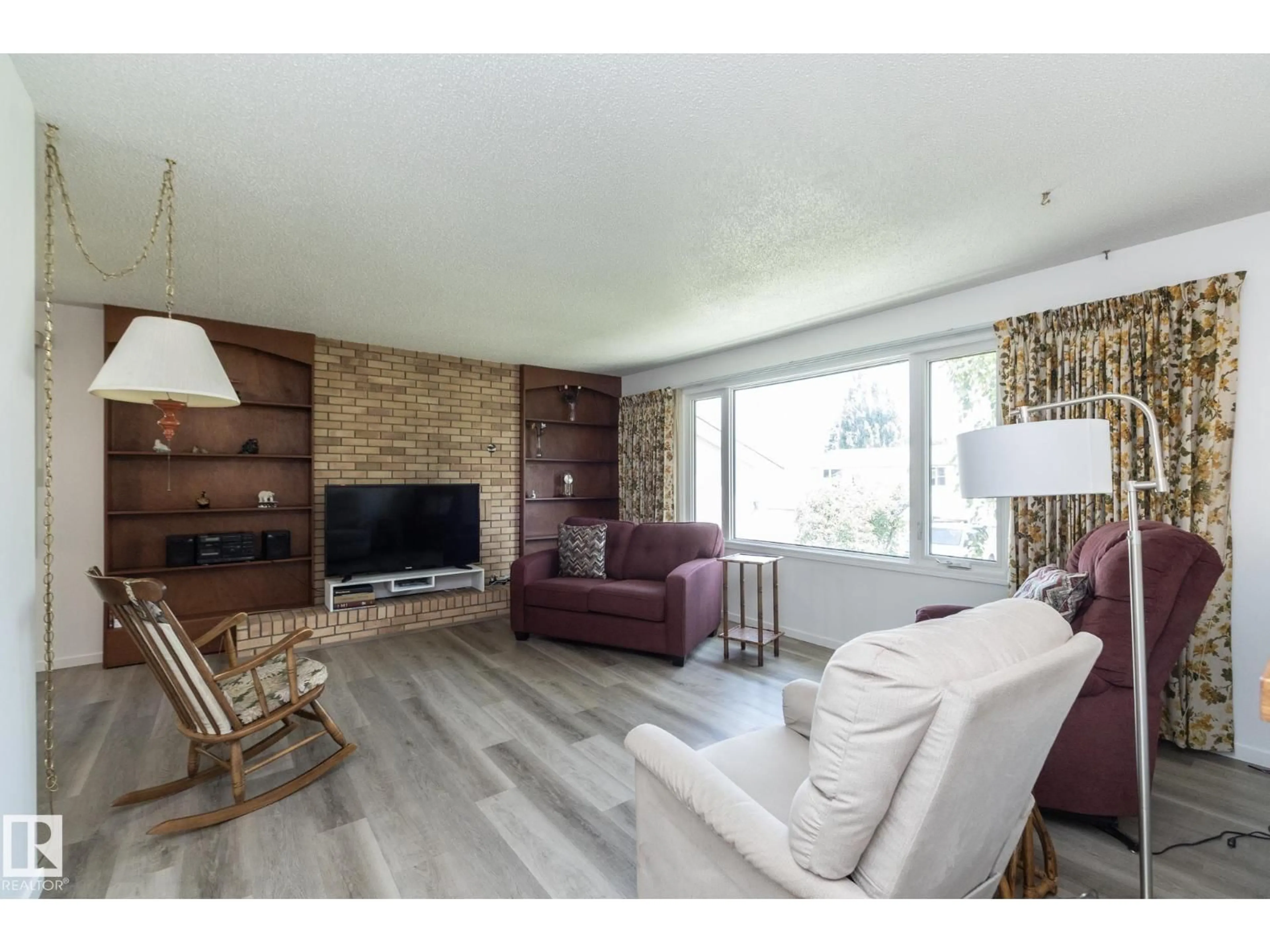 Living room with furniture, wood/laminate floor for 4302 53 ST, Leduc Alberta T9E5B1