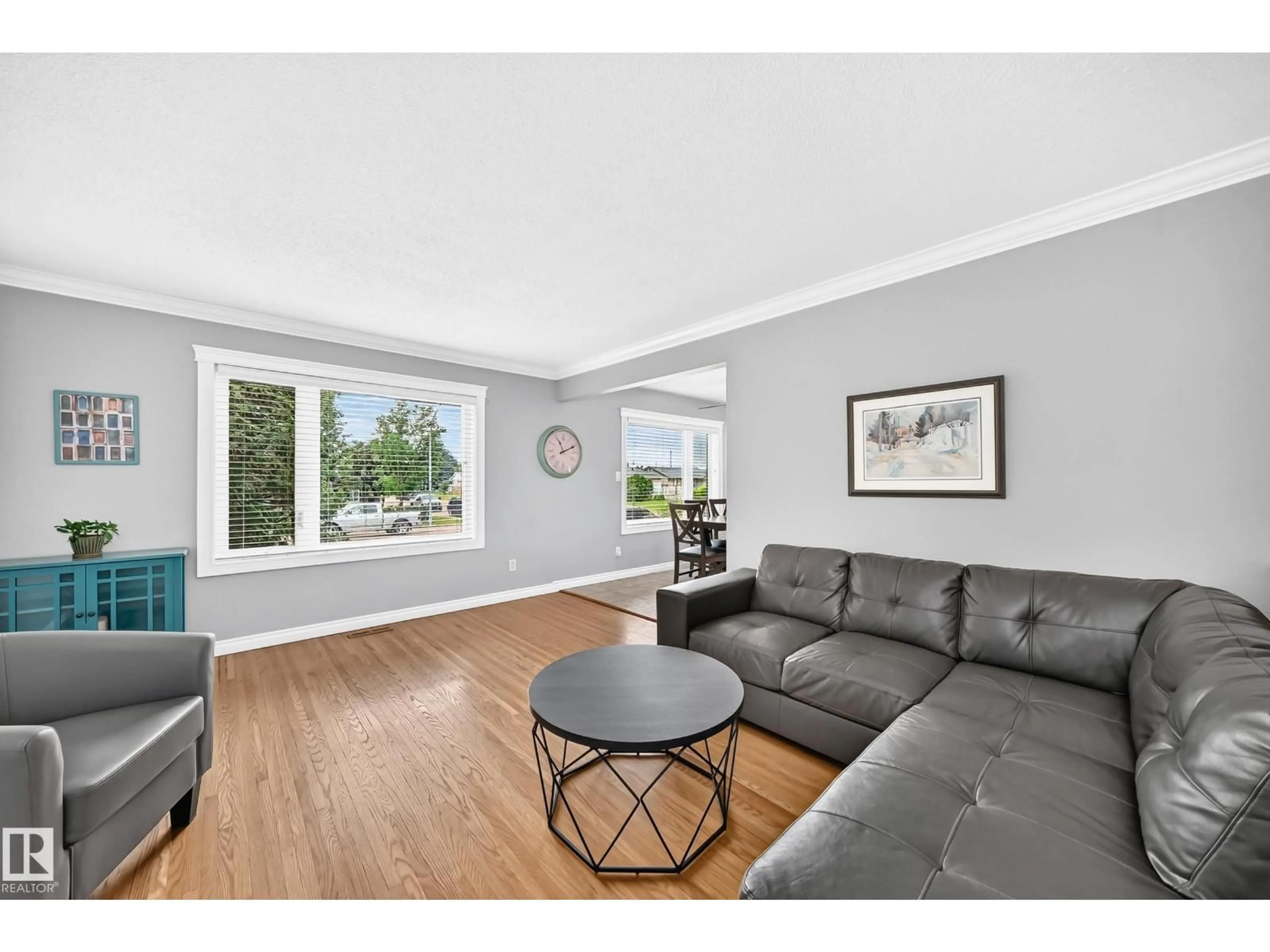 Living room with furniture, wood/laminate floor for 7916 130 AV, Edmonton Alberta T5C1Y5
