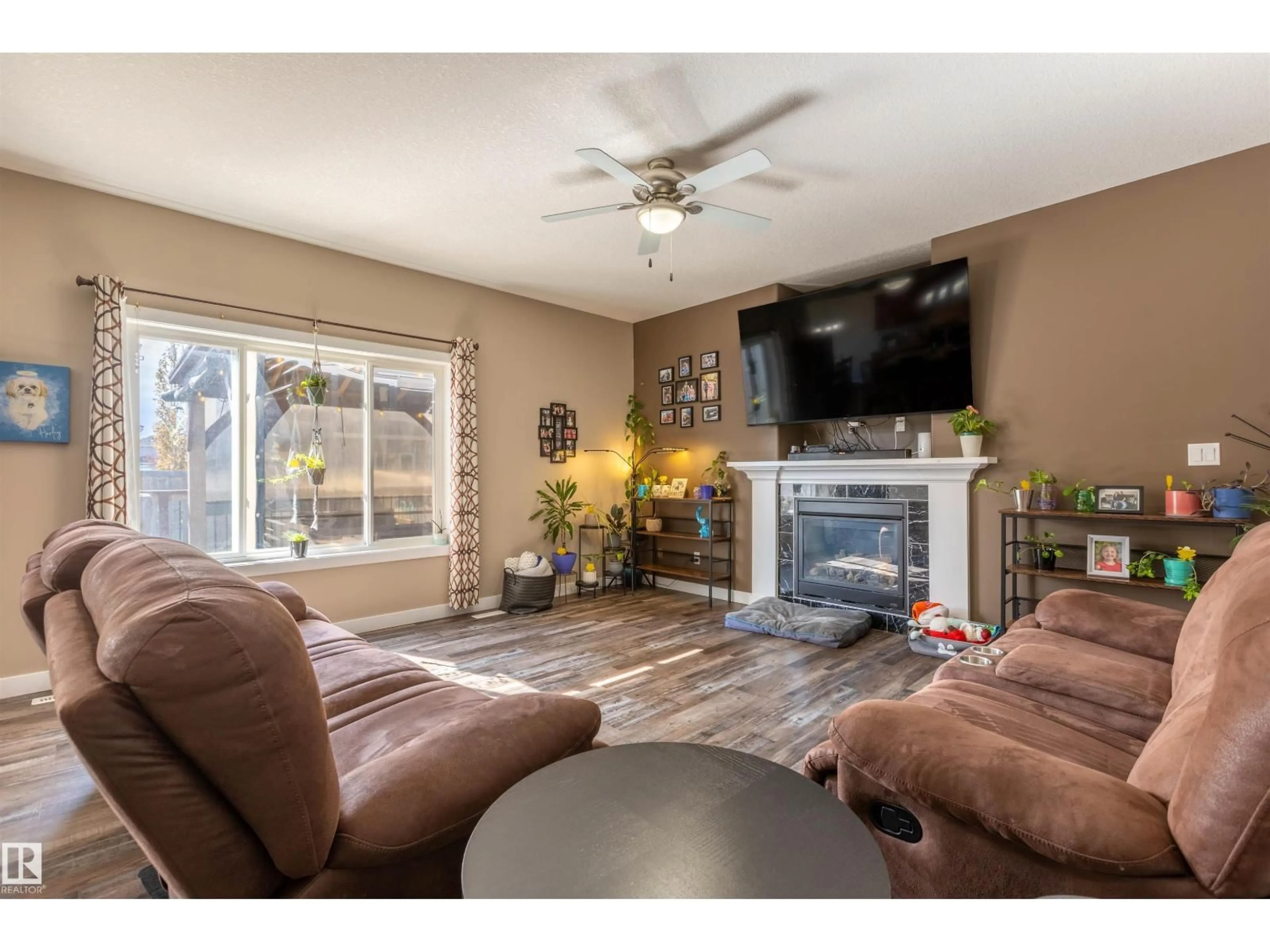 Living room with furniture, wood/laminate floor for 8907 97A AV, Morinville Alberta T8R2N6