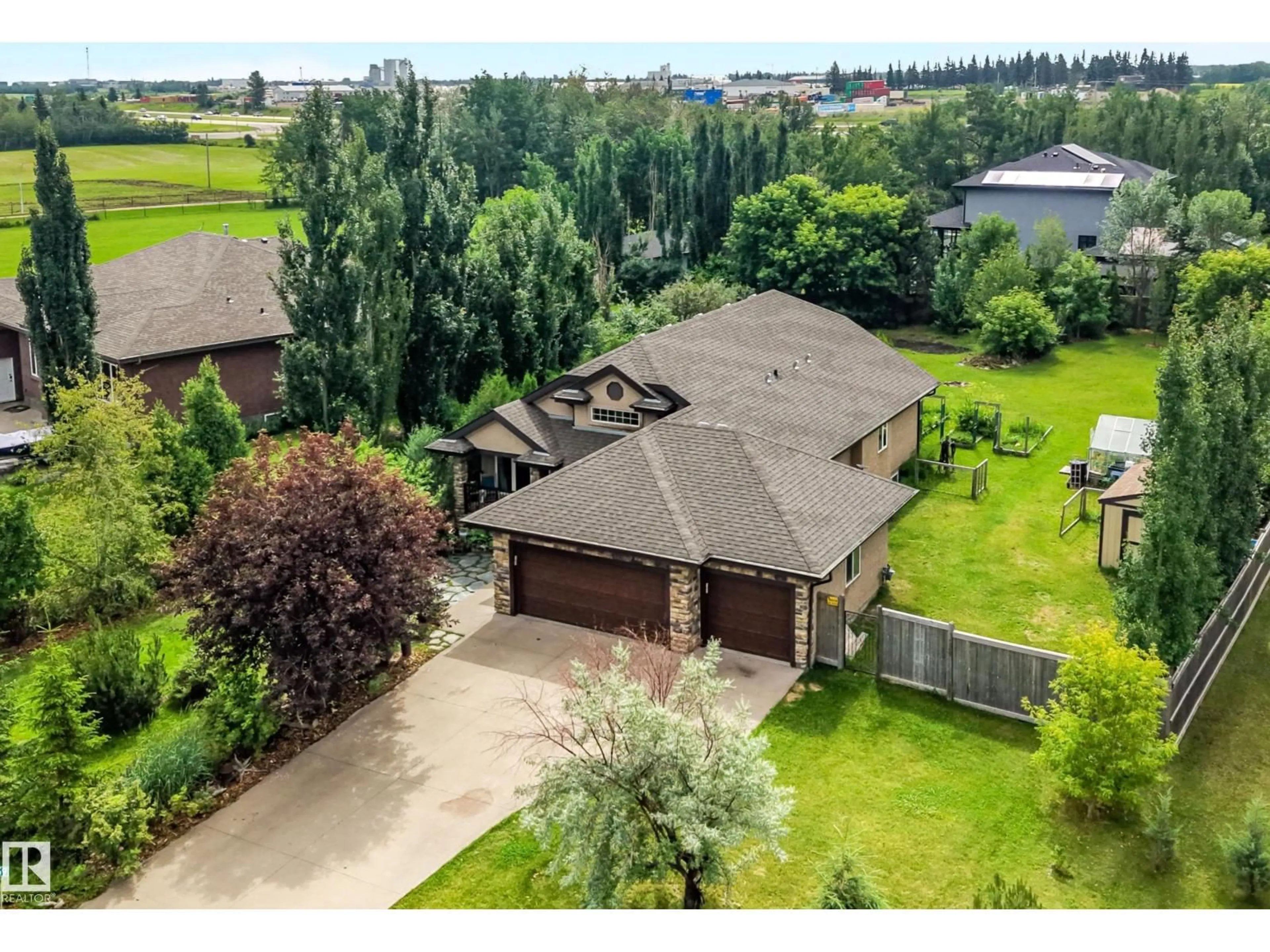 A pic from outside/outdoor area/front of a property/back of a property/a pic from drone, water/lake/river/ocean view for 59 26107 TWP ROAD 532 A, Rural Parkland County Alberta T6J2R2