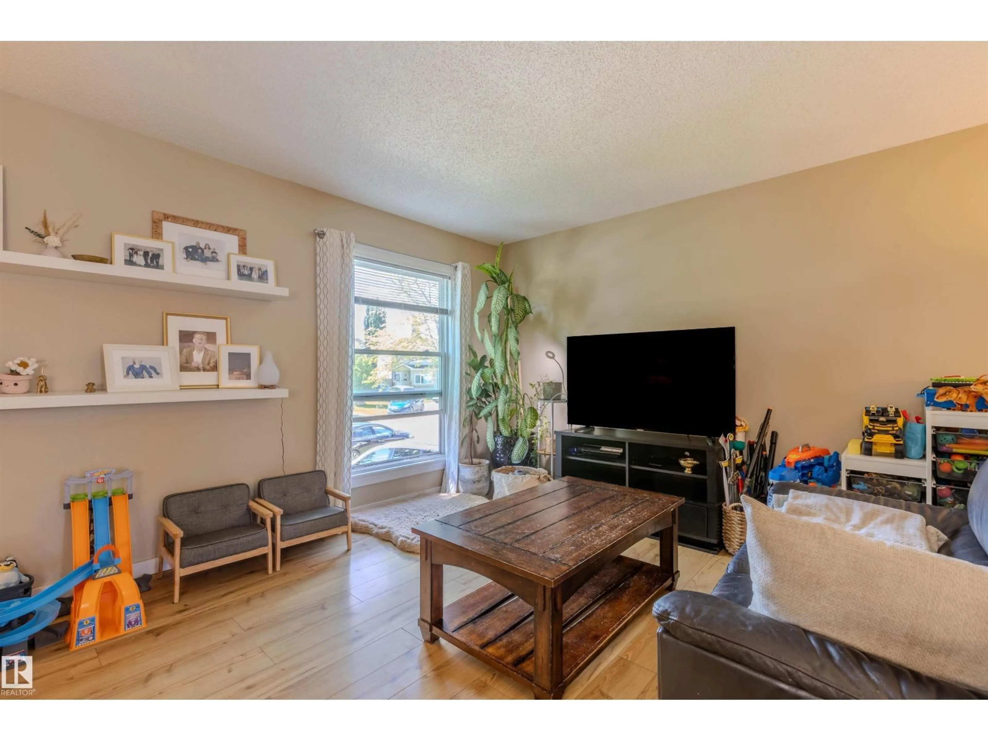 Living room with furniture, wood/laminate floor for 10408 98 AV, Morinville Alberta T8R1C8