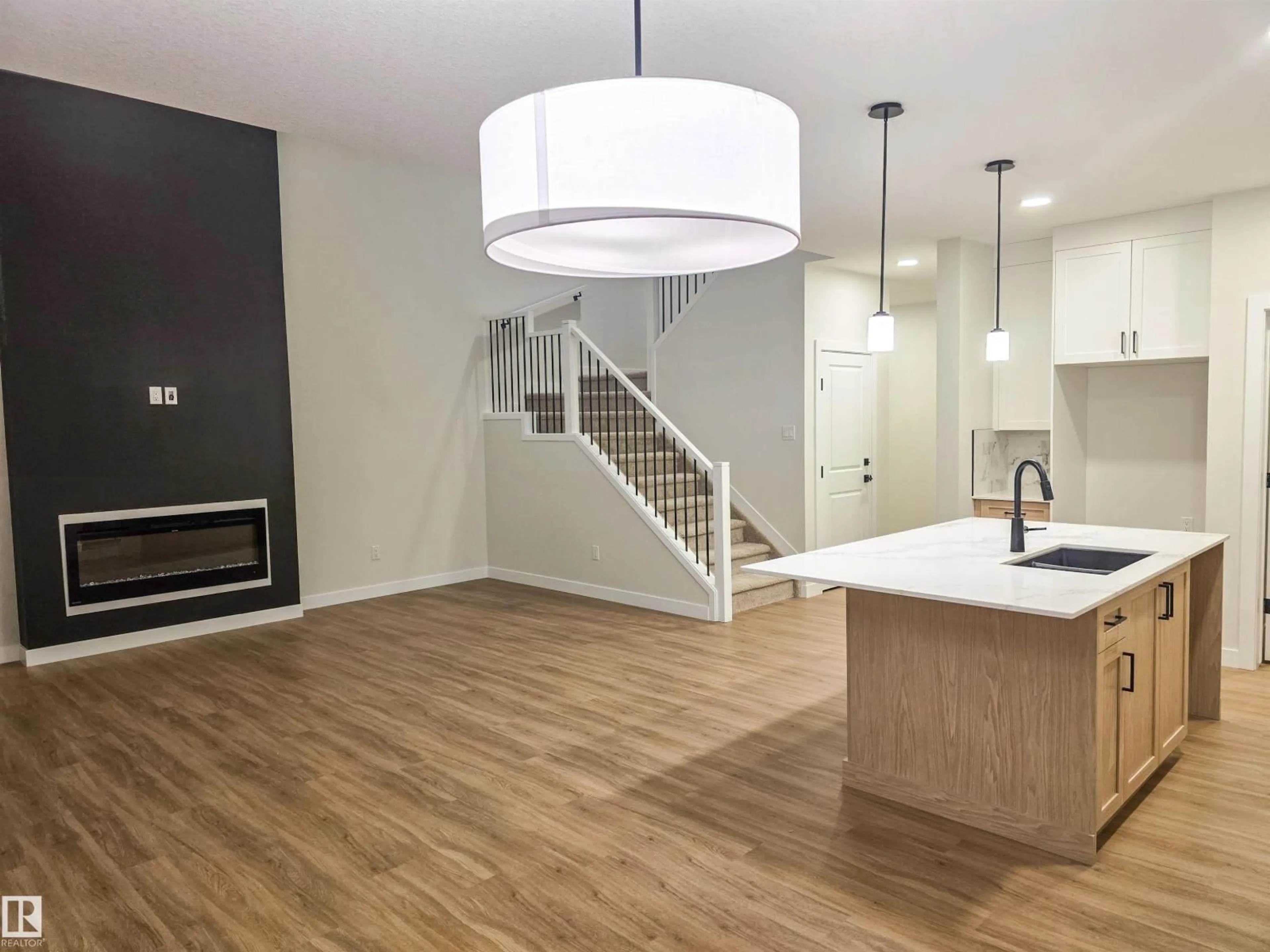 Open concept kitchen, wood/laminate floor for 50 WILLOW LI, Fort Saskatchewan Alberta T8L0W8
