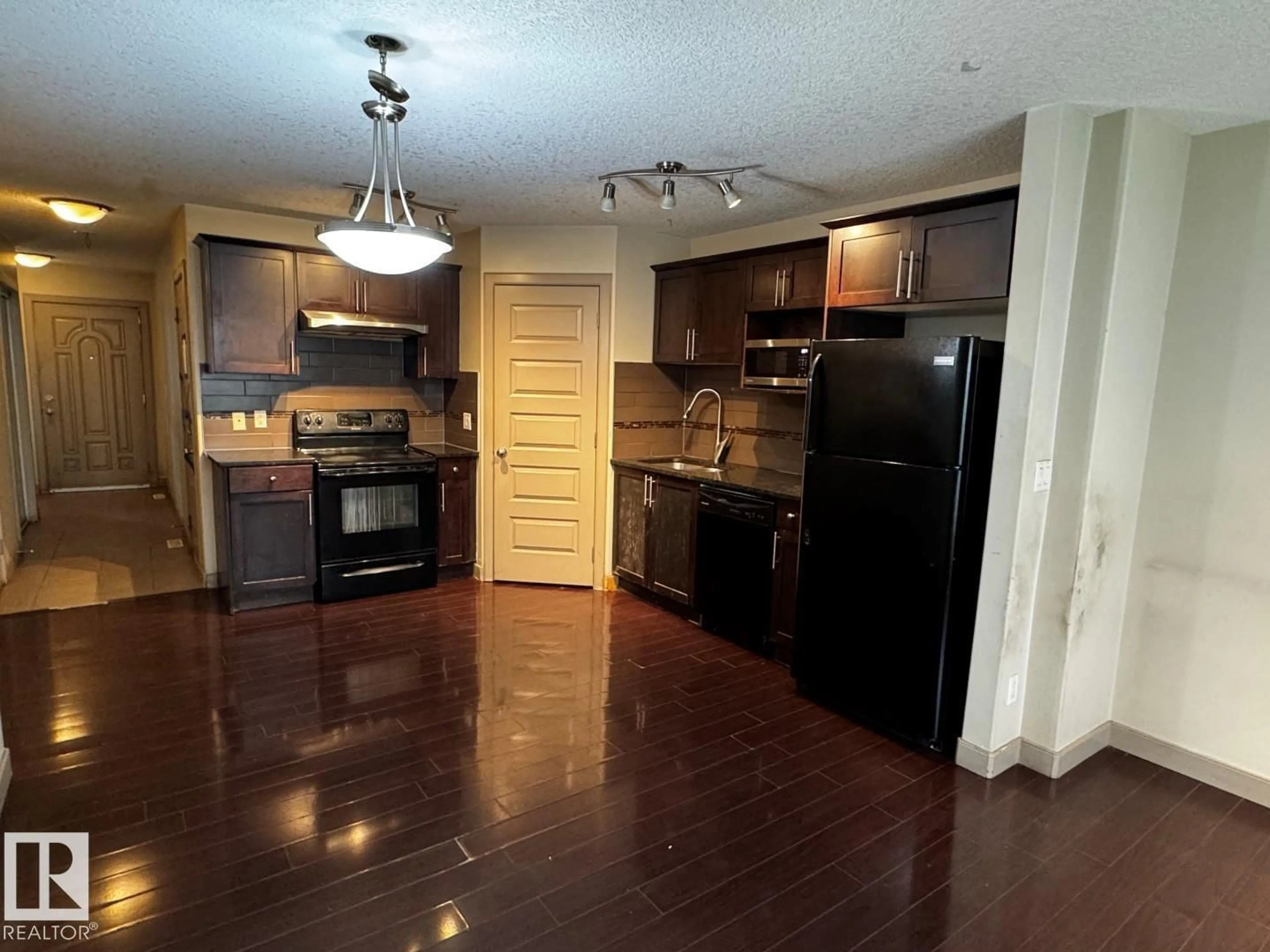 Open concept kitchen, wood/laminate floor for 6 - 1820 34 AV, Edmonton Alberta T6T0N9