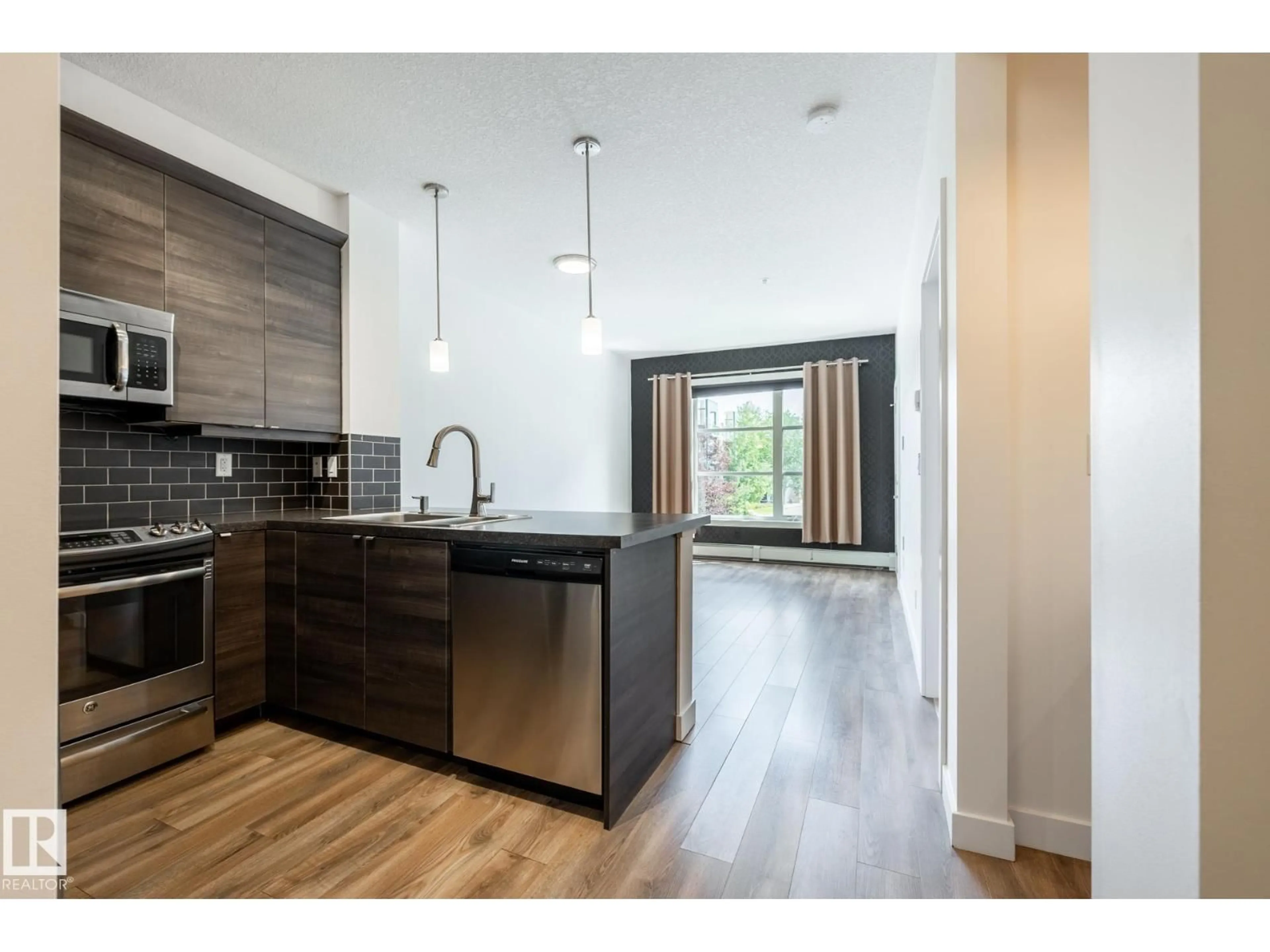 Open concept kitchen, wood/laminate floor for #215 - 2590 ANDERSON WY, Edmonton Alberta T6W0R2