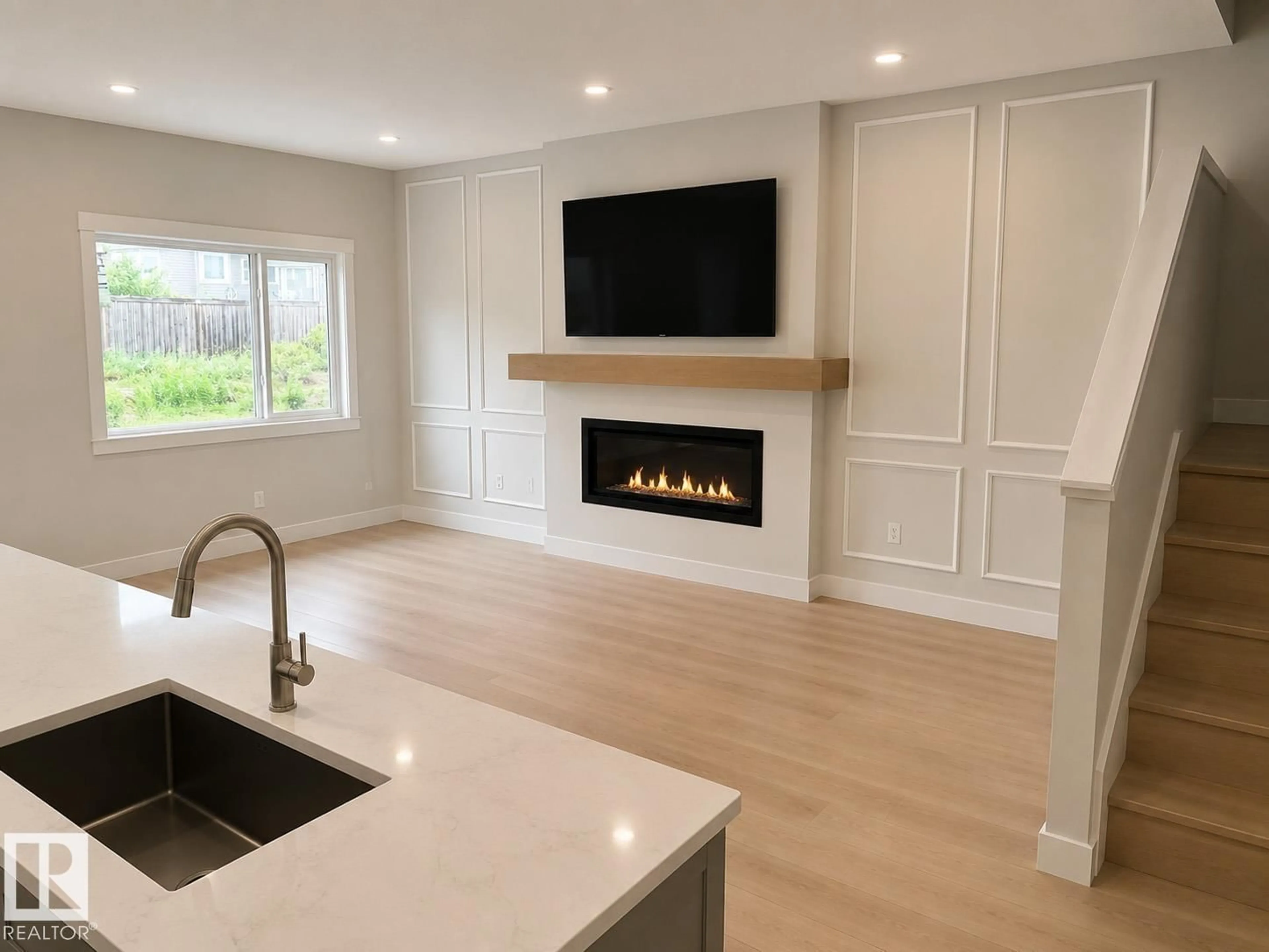Open concept kitchen, wood/laminate floor for 189 WYATT RG, Fort Saskatchewan Alberta T8L0Y3