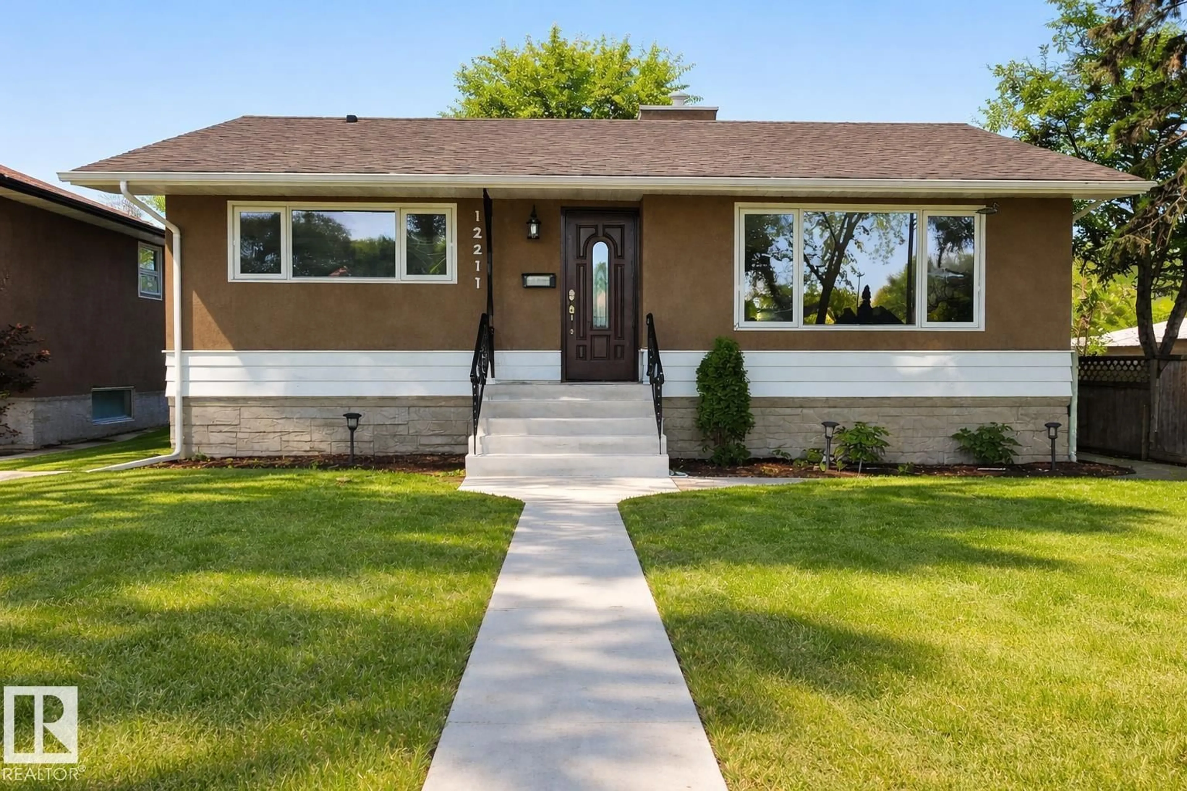 Home with vinyl exterior material, street for NW - 12211 52 ST, Edmonton Alberta T5W3K3