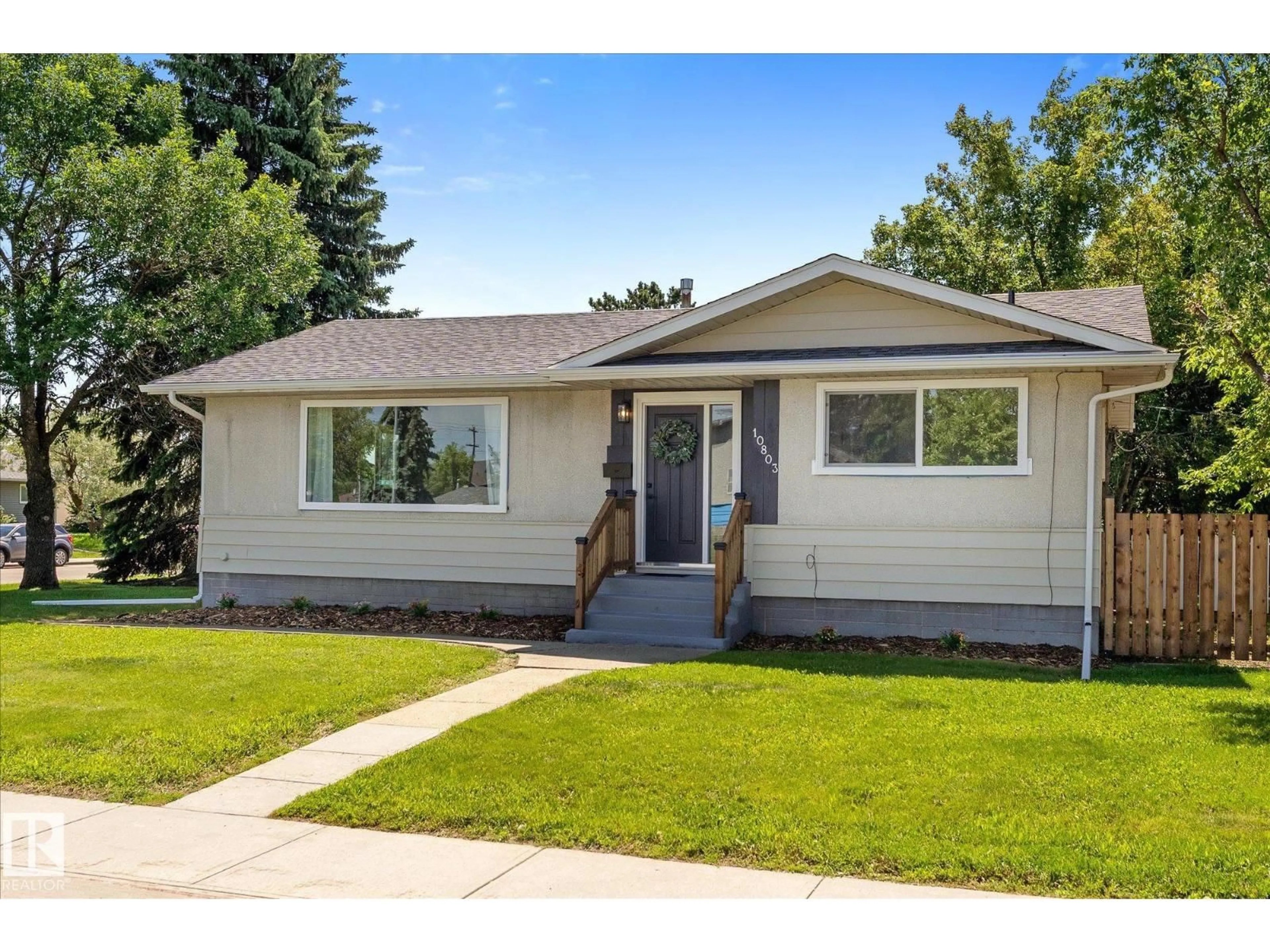 Home with vinyl exterior material, street for 10803 136 AV, Edmonton Alberta T5E1W6