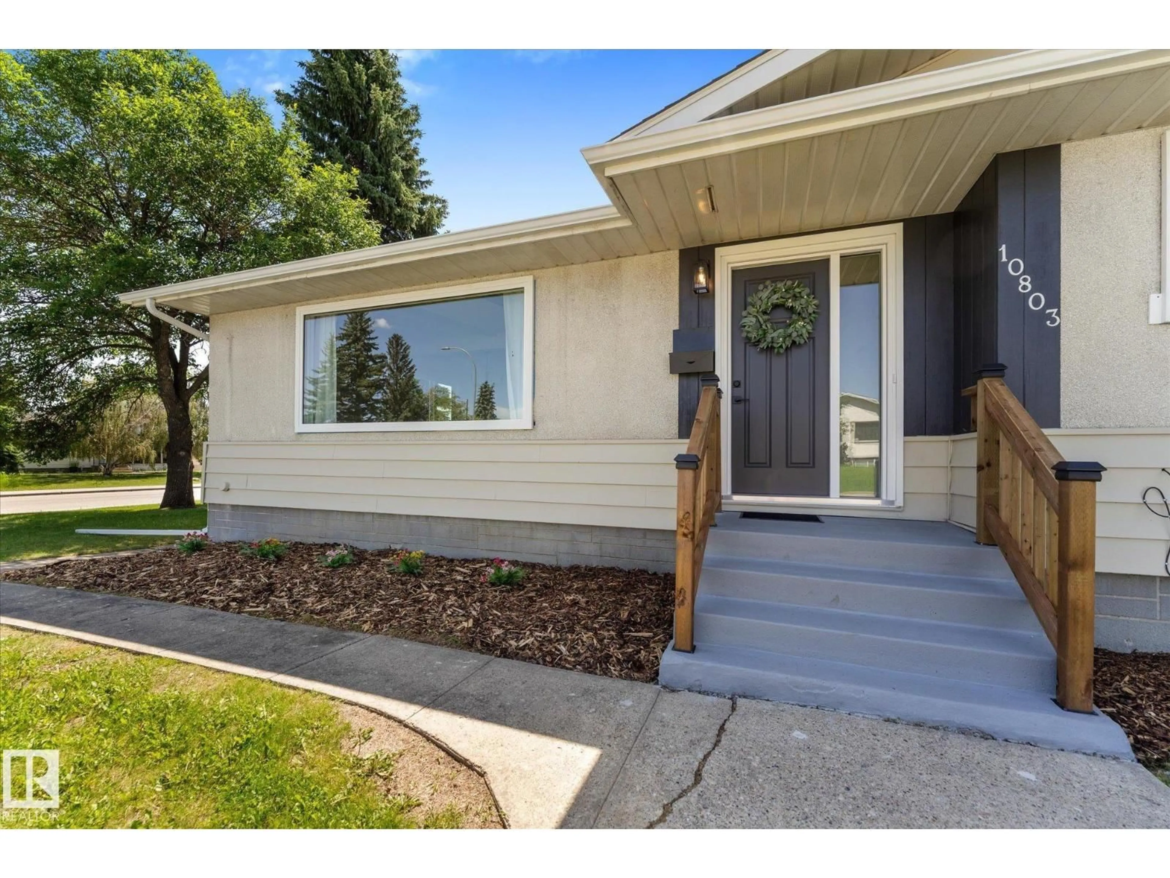 Home with vinyl exterior material, street for 10803 136 AV, Edmonton Alberta T5E1W6