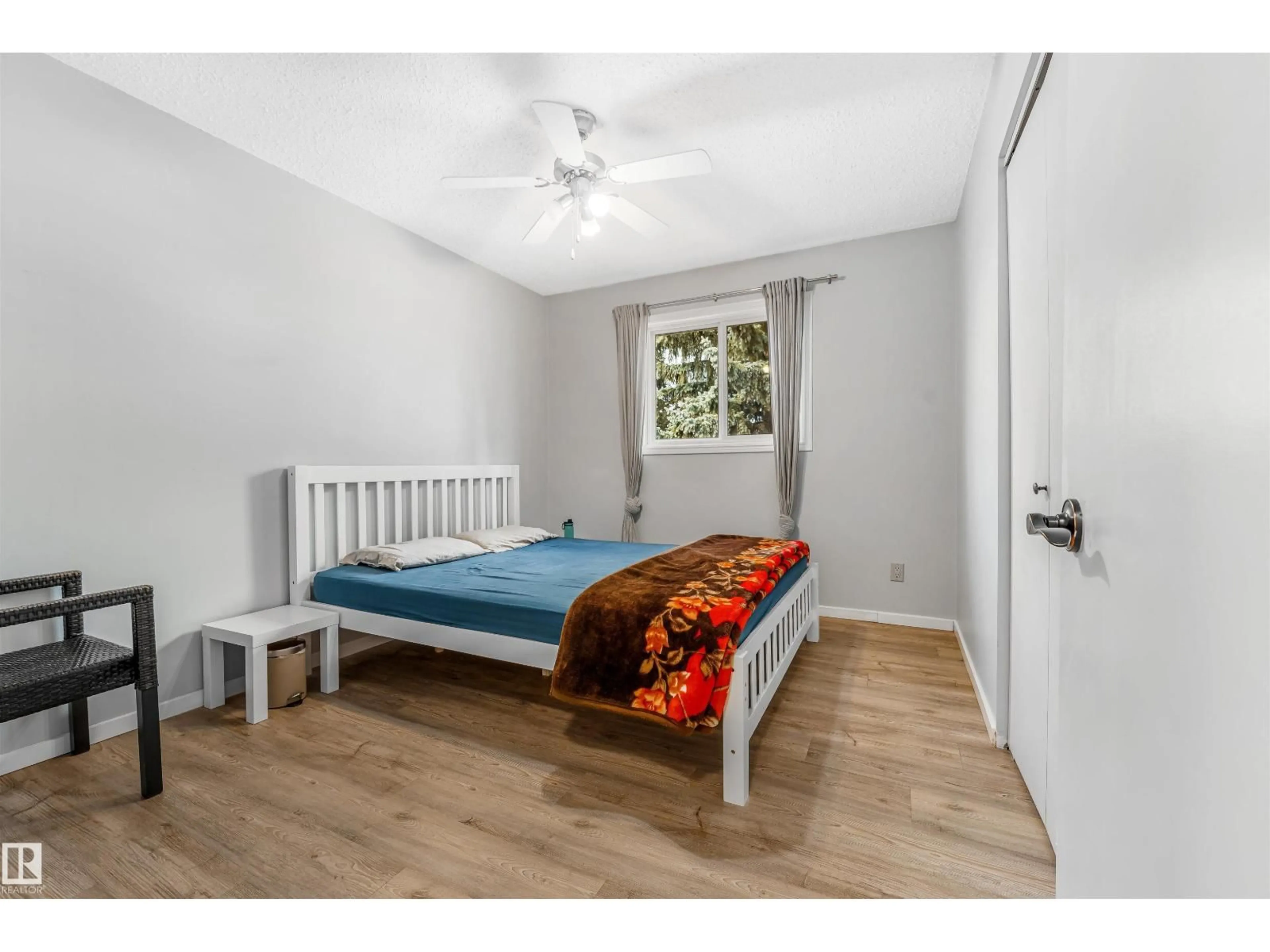 Bedroom with bed, wood/laminate floor for NW - 2437 89 ST, Edmonton Alberta T6K2Y8