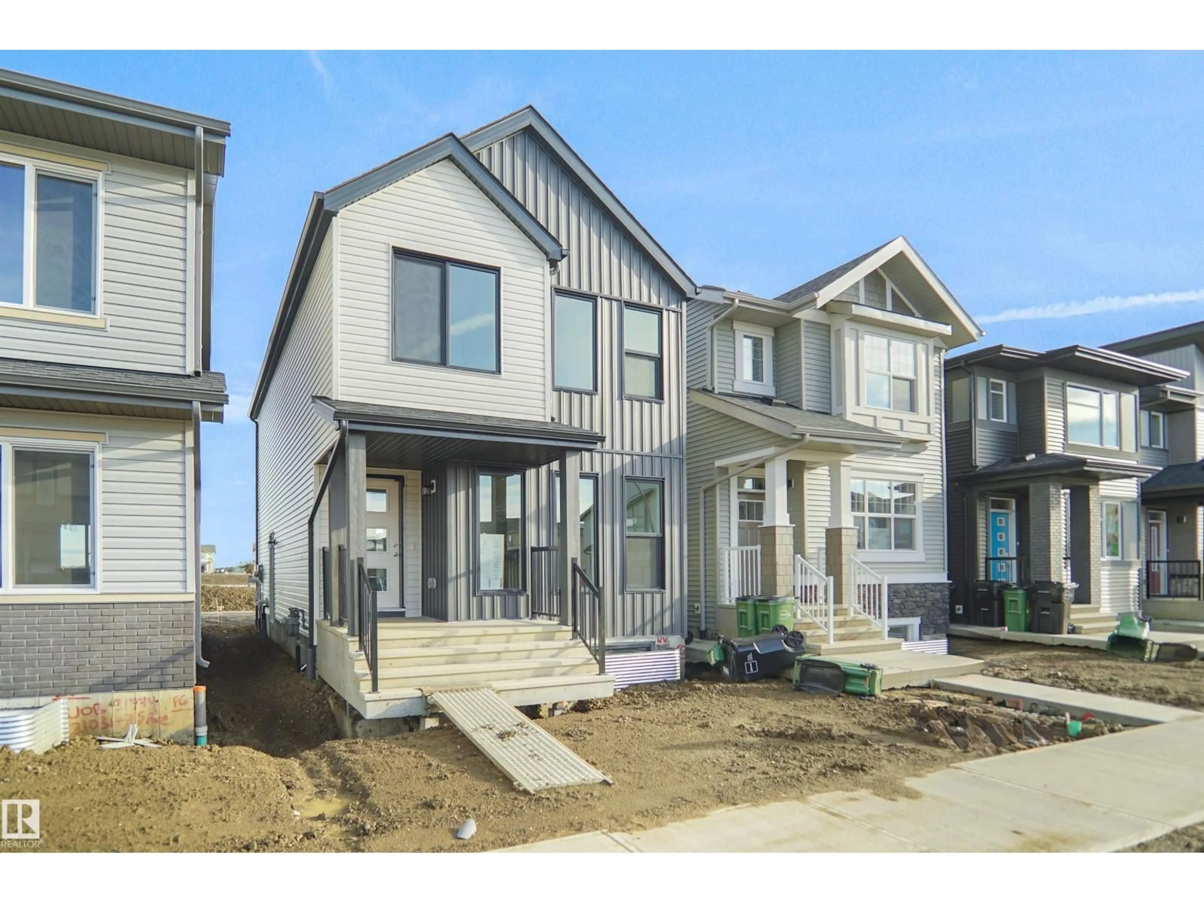 Home with vinyl exterior material, street for NW - 21035 25 AV, Edmonton Alberta T5Y4G2