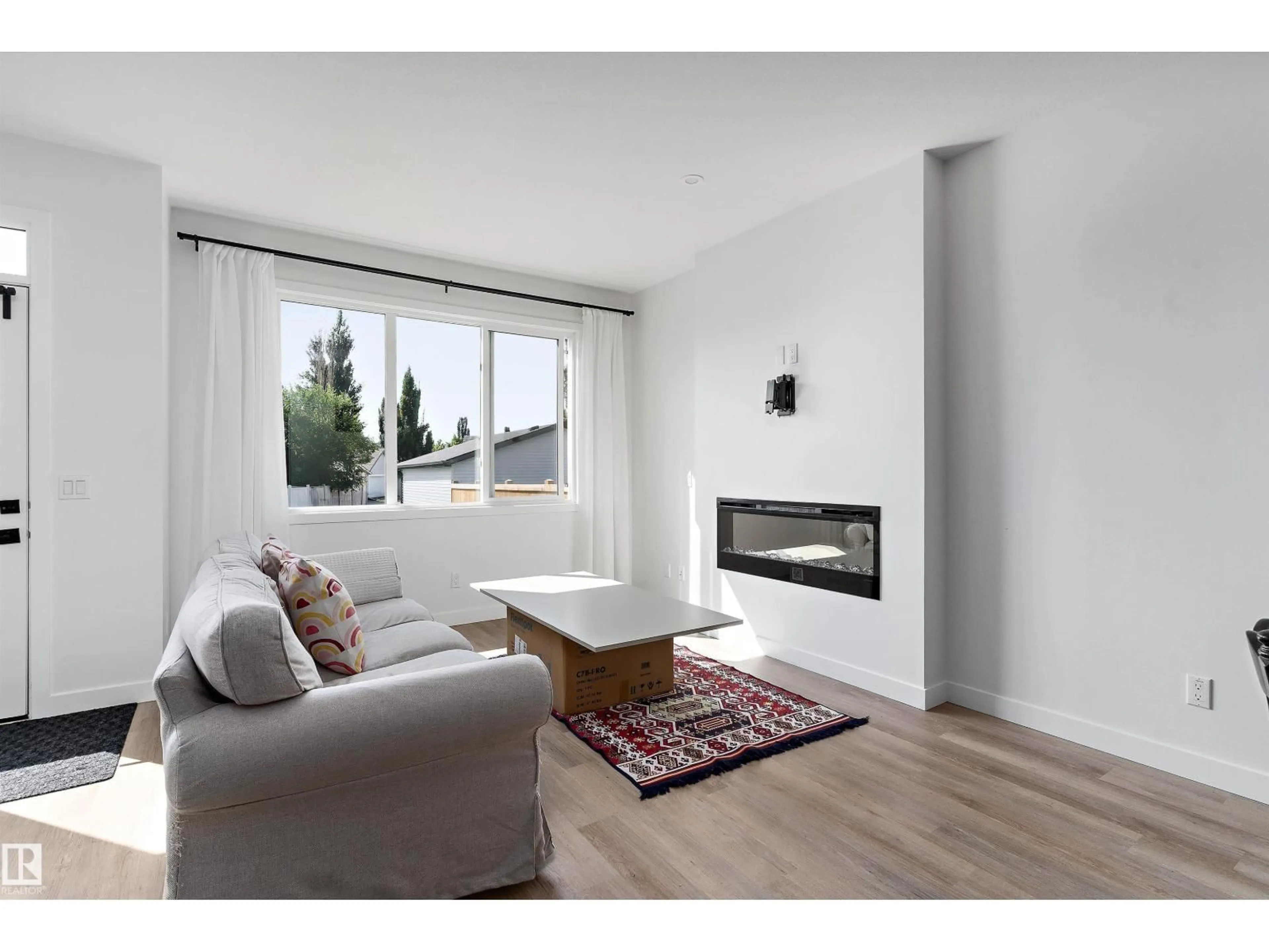 Living room with furniture, wood/laminate floor for 1439 GOODSPEED LN, Edmonton Alberta T5T0W2