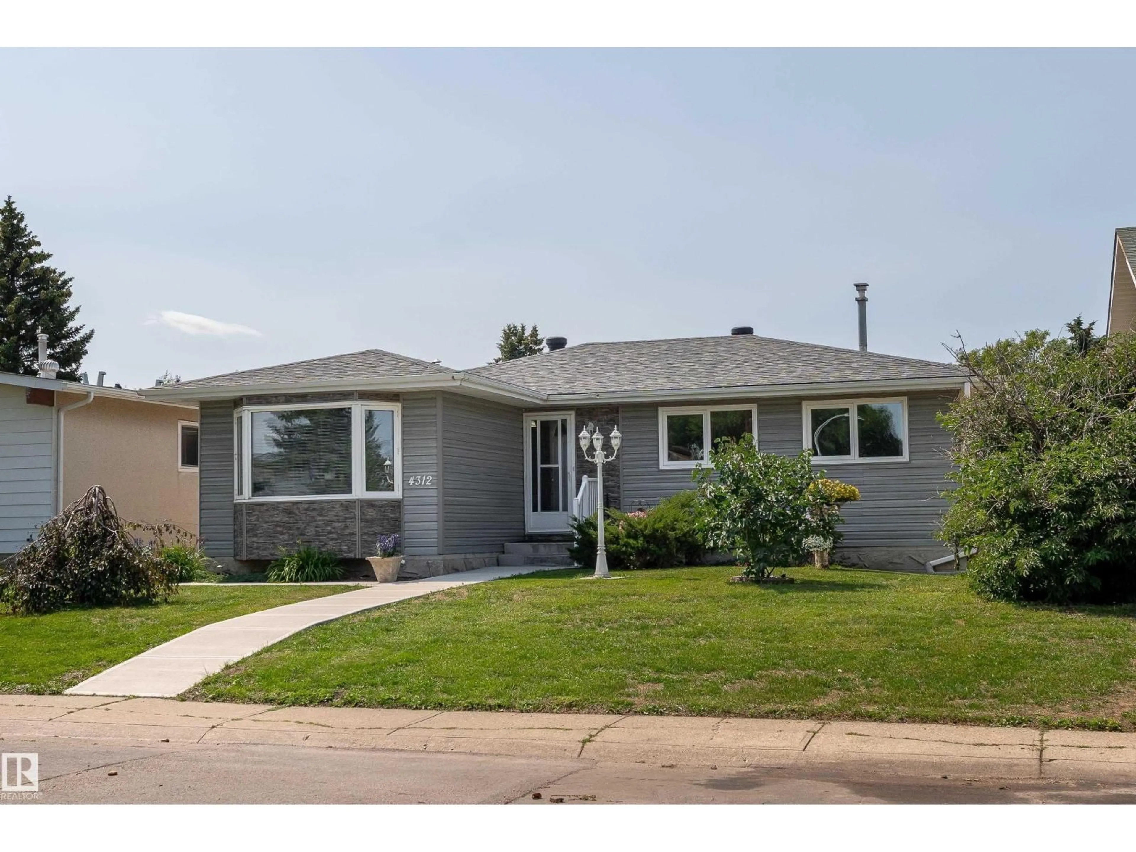 Home with vinyl exterior material, street for NW - 4312 70 ST, Edmonton Alberta T6K0V1
