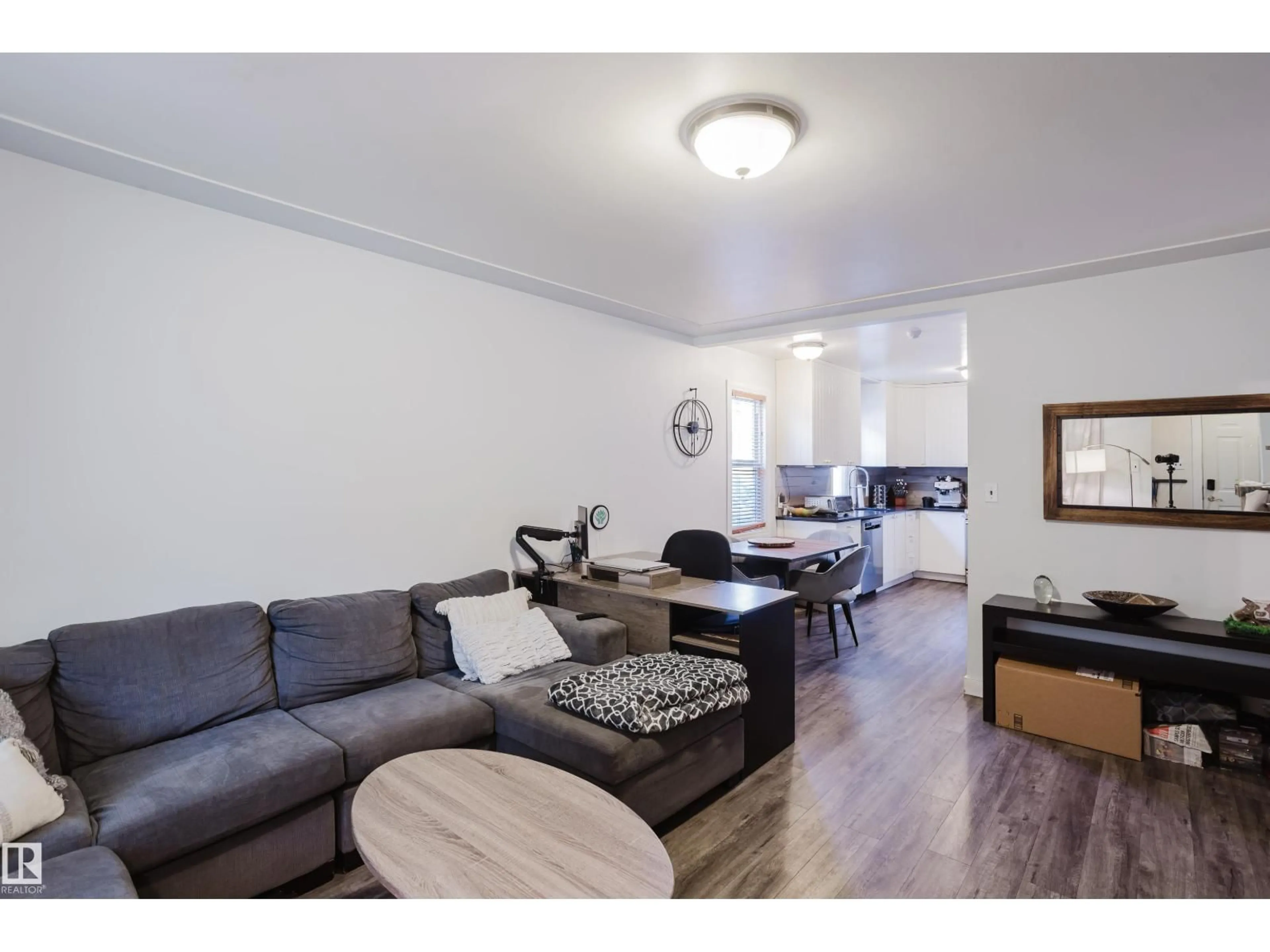 Living room with furniture, wood/laminate floor for 10623 76 AV, Edmonton Alberta T6E1L6
