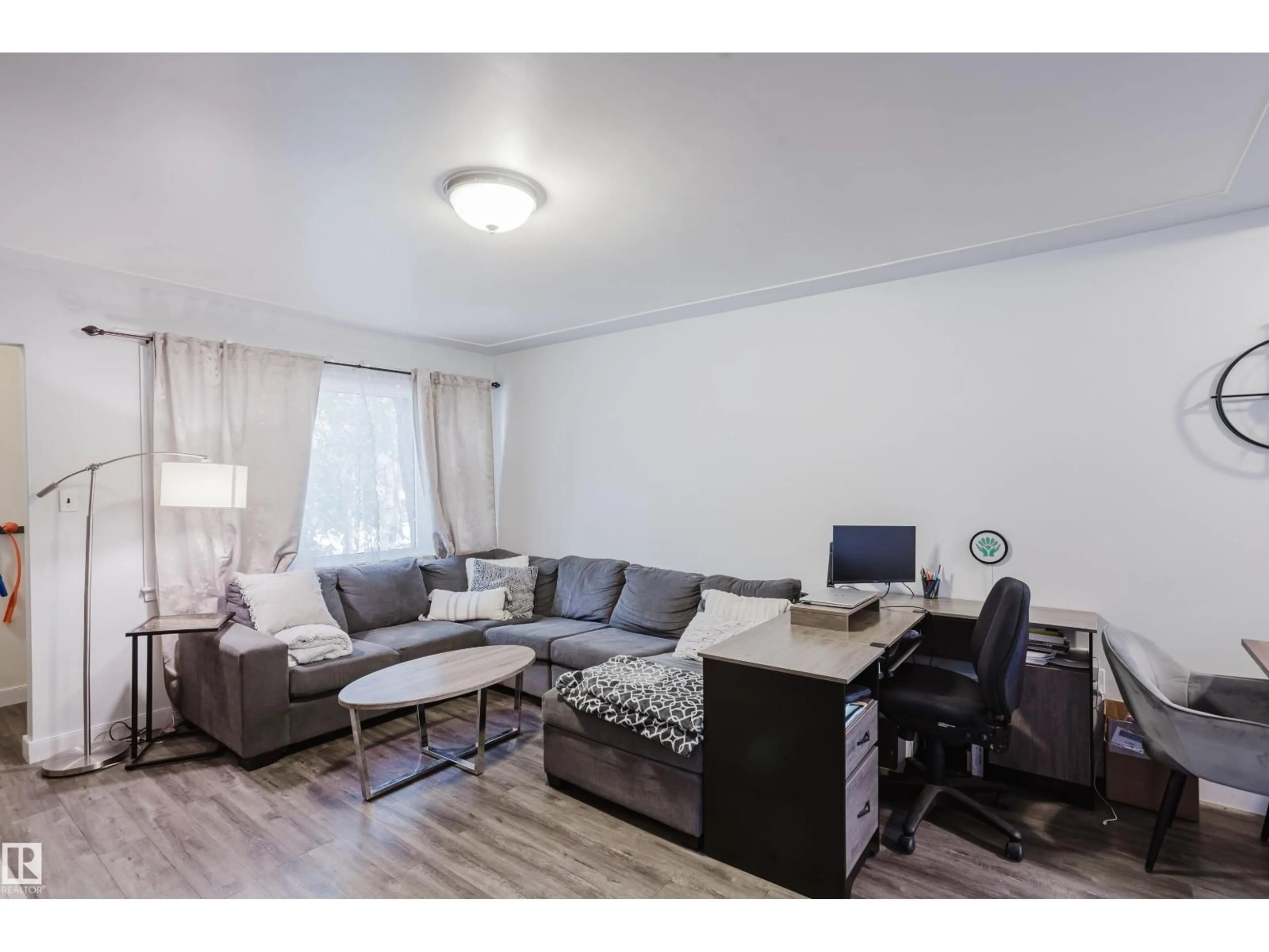 Living room with furniture, wood/laminate floor for 10623 76 AV, Edmonton Alberta T6E1L6