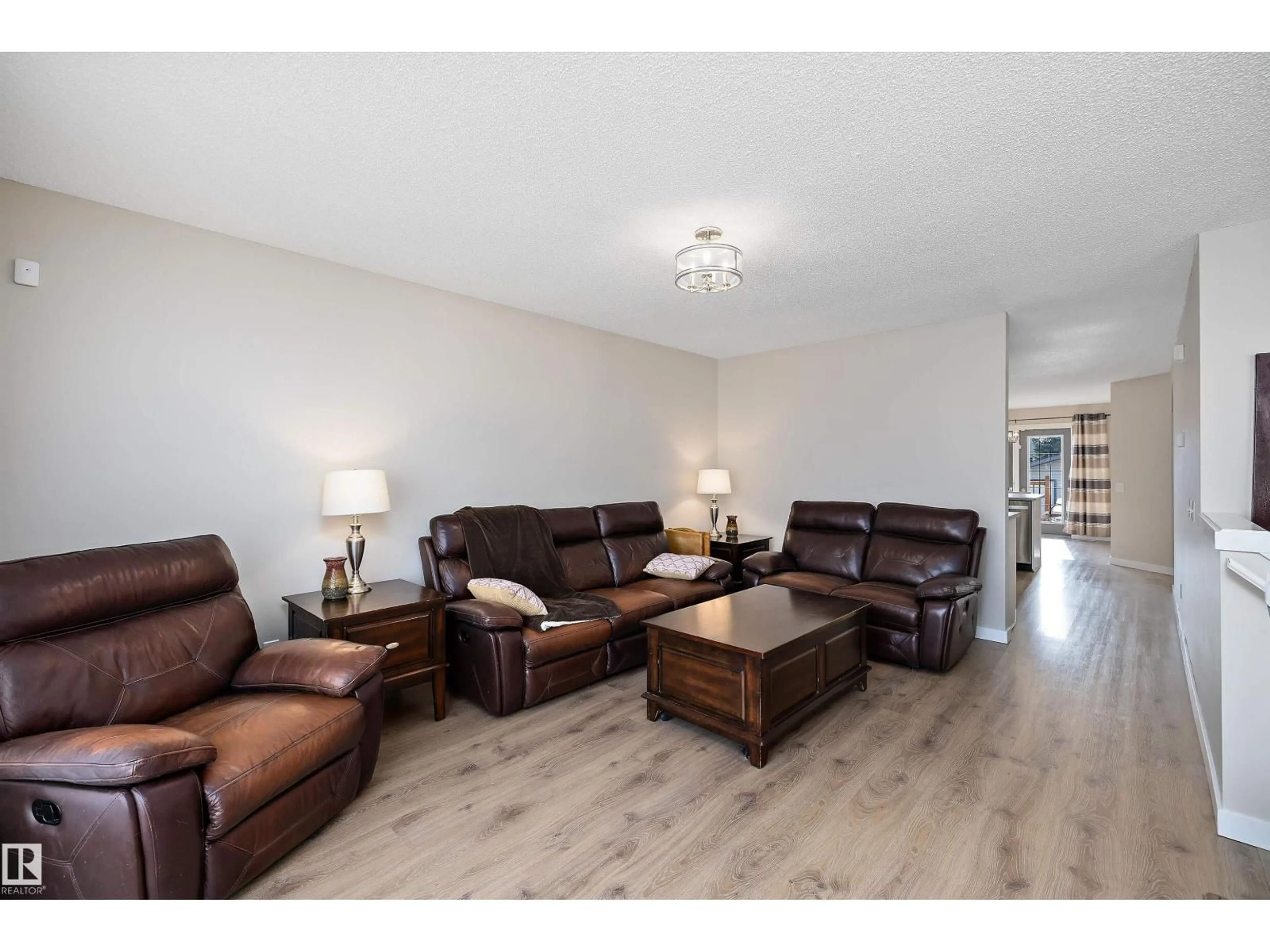 Living room with furniture, wood/laminate floor for 3019 33 AV, Edmonton Alberta T6T1X2