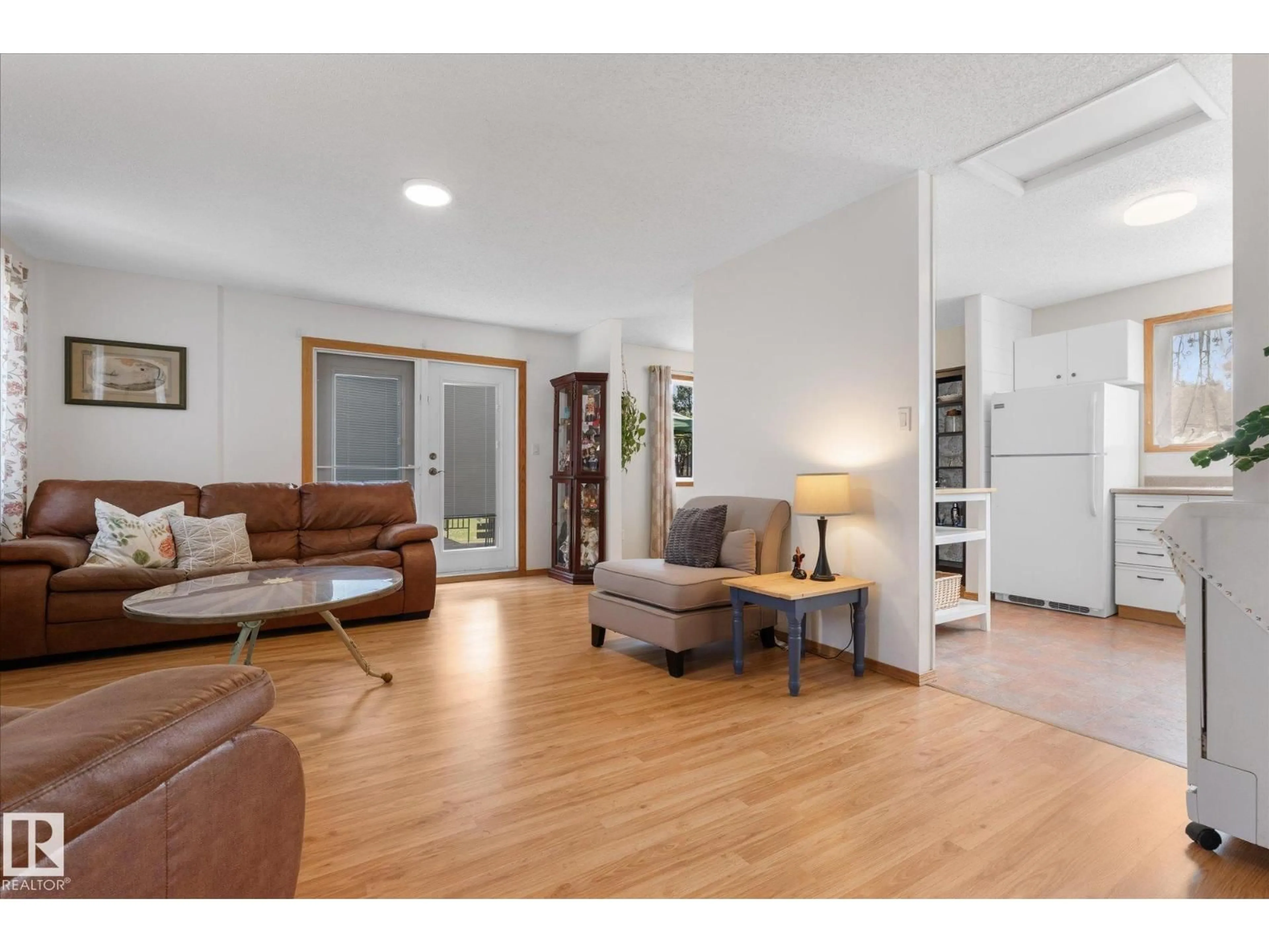 Living room with furniture, wood/laminate floor for 76 CHUNGO CR, Devon Alberta T9G1V5