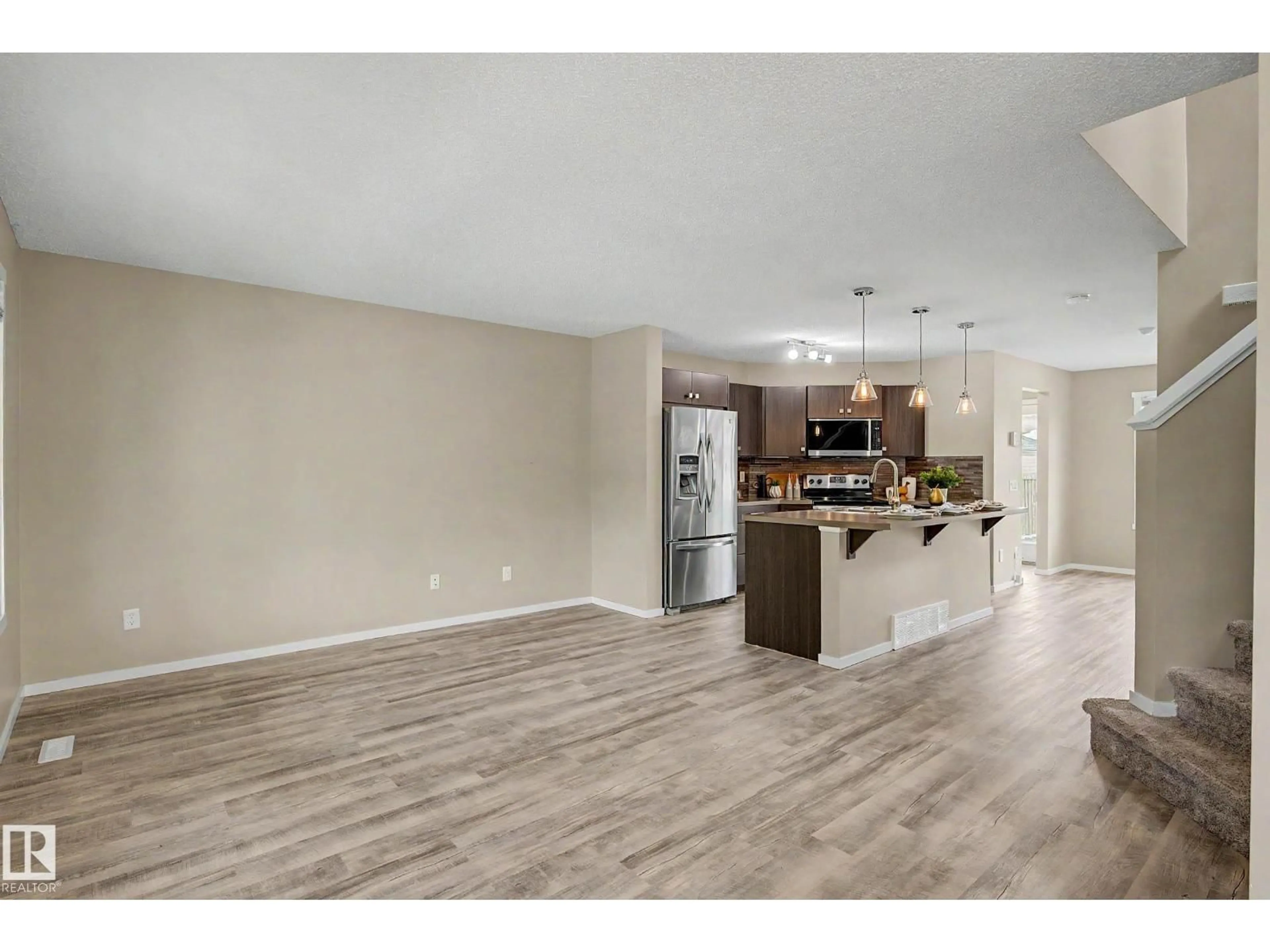 Open concept kitchen, wood/laminate floor for 4218 ALLAN LINK LI, Edmonton Alberta T6W2K1