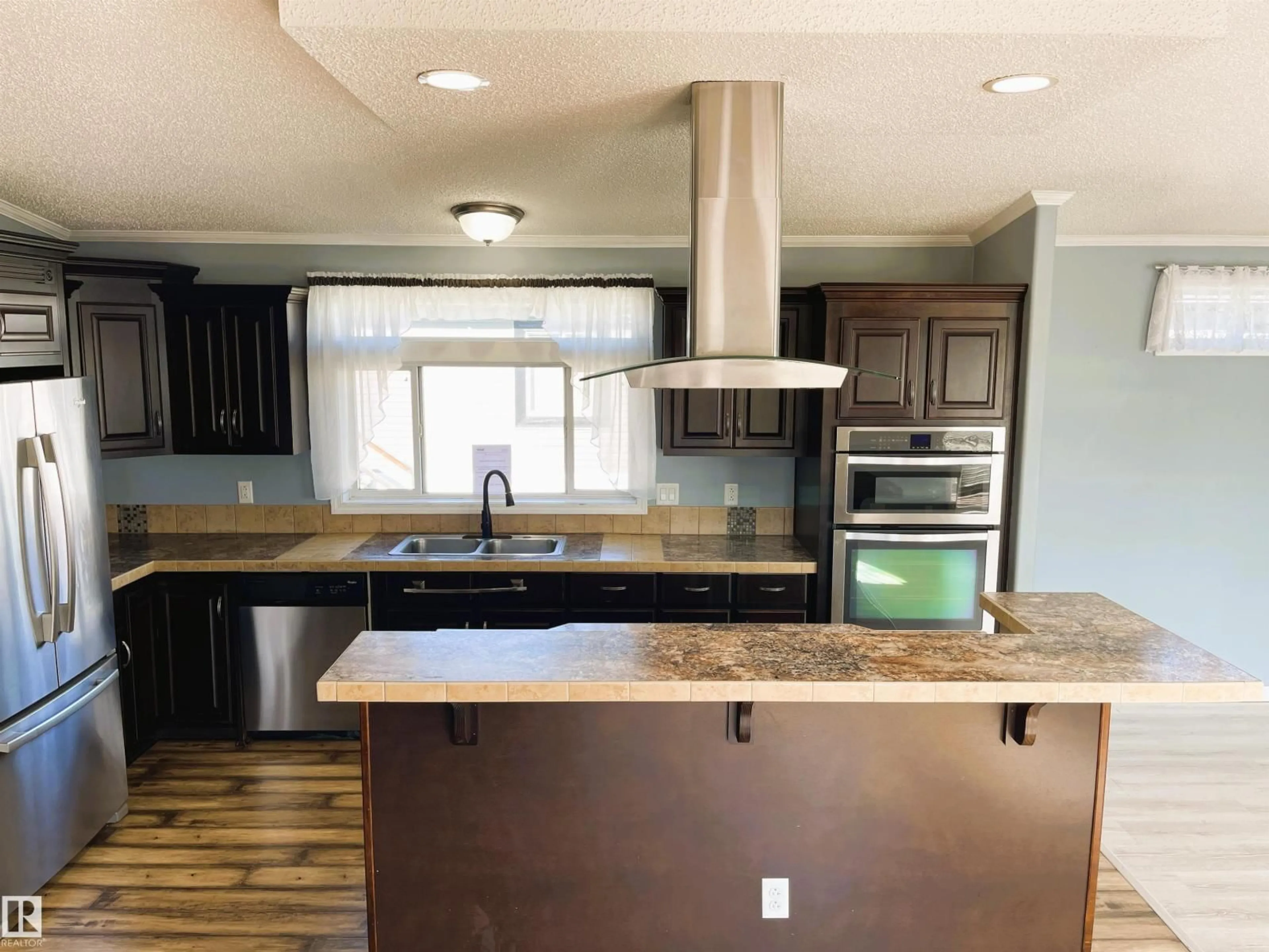 Open concept kitchen, wood/laminate floor for 5102 51 AV, Fort Kent Alberta T0A1H0