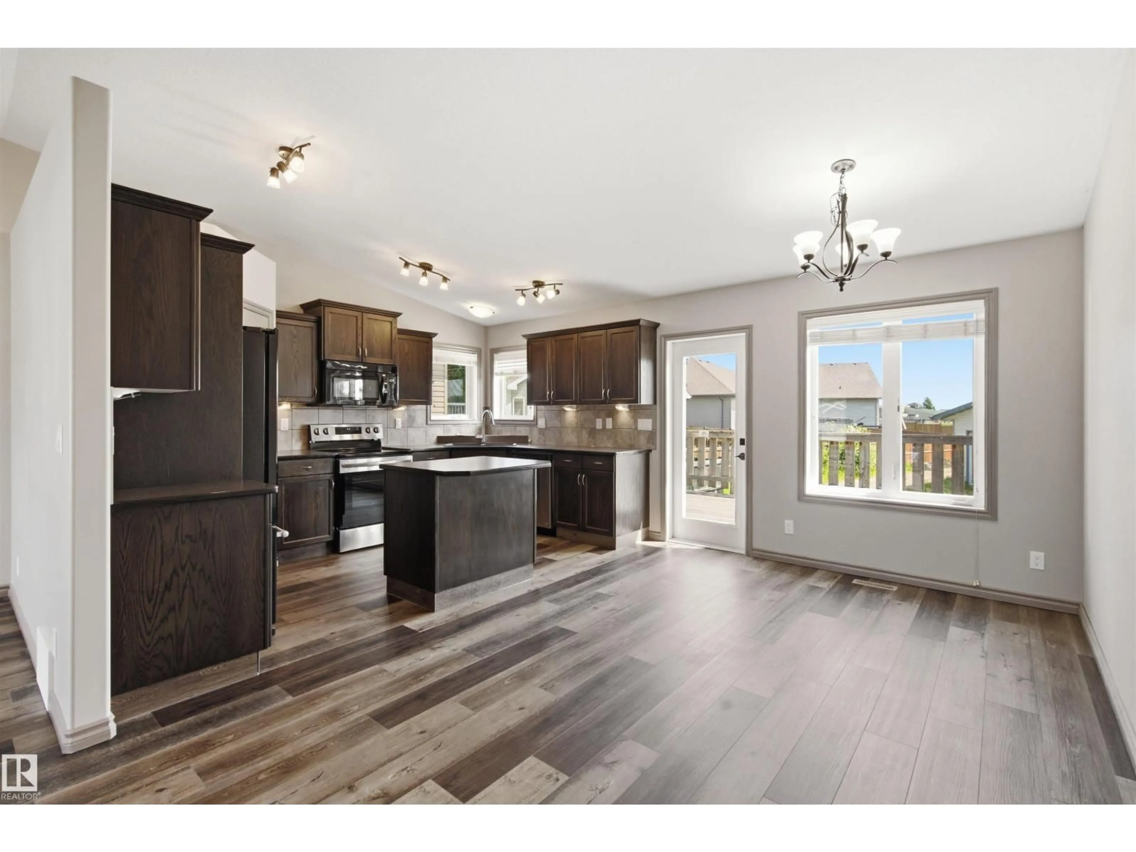 Open concept kitchen, wood/laminate floor for 3814 45 AV, Bonnyville Town Alberta T9N0A8