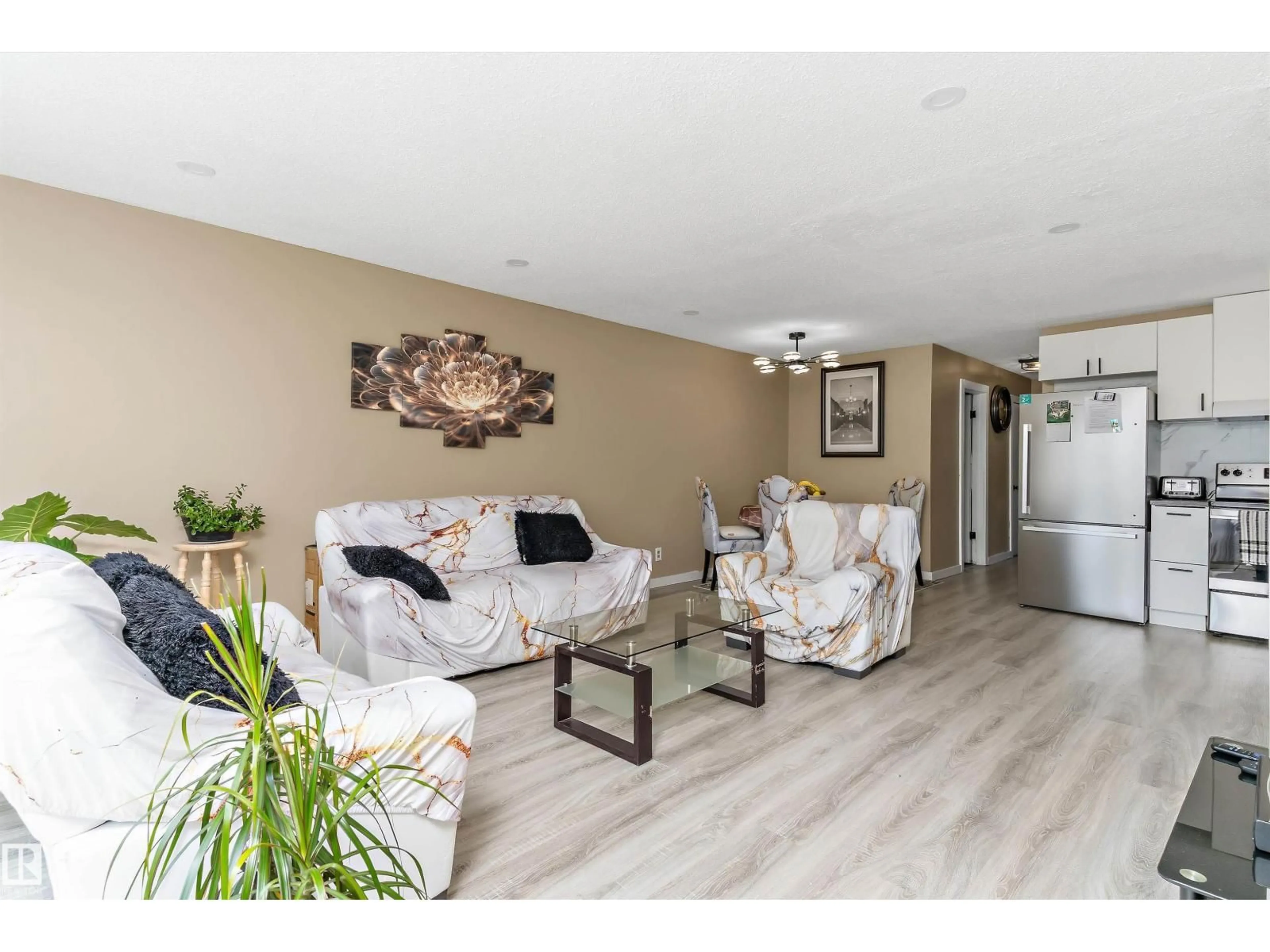 Living room with furniture, wood/laminate floor for 3708 133 AV, Edmonton Alberta T5A3E9