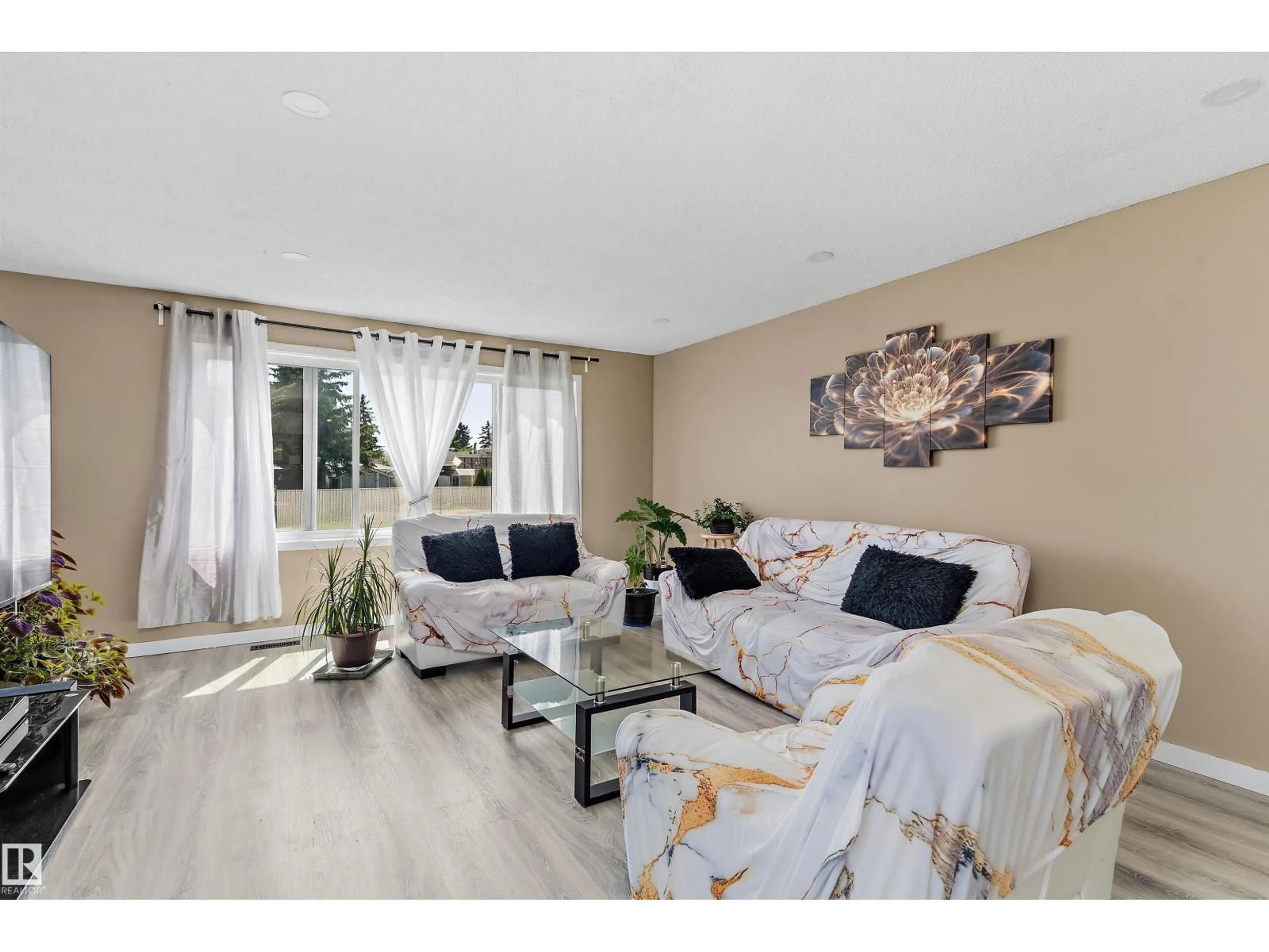 Living room with furniture, wood/laminate floor for 3708 133 AV, Edmonton Alberta T5A3E9