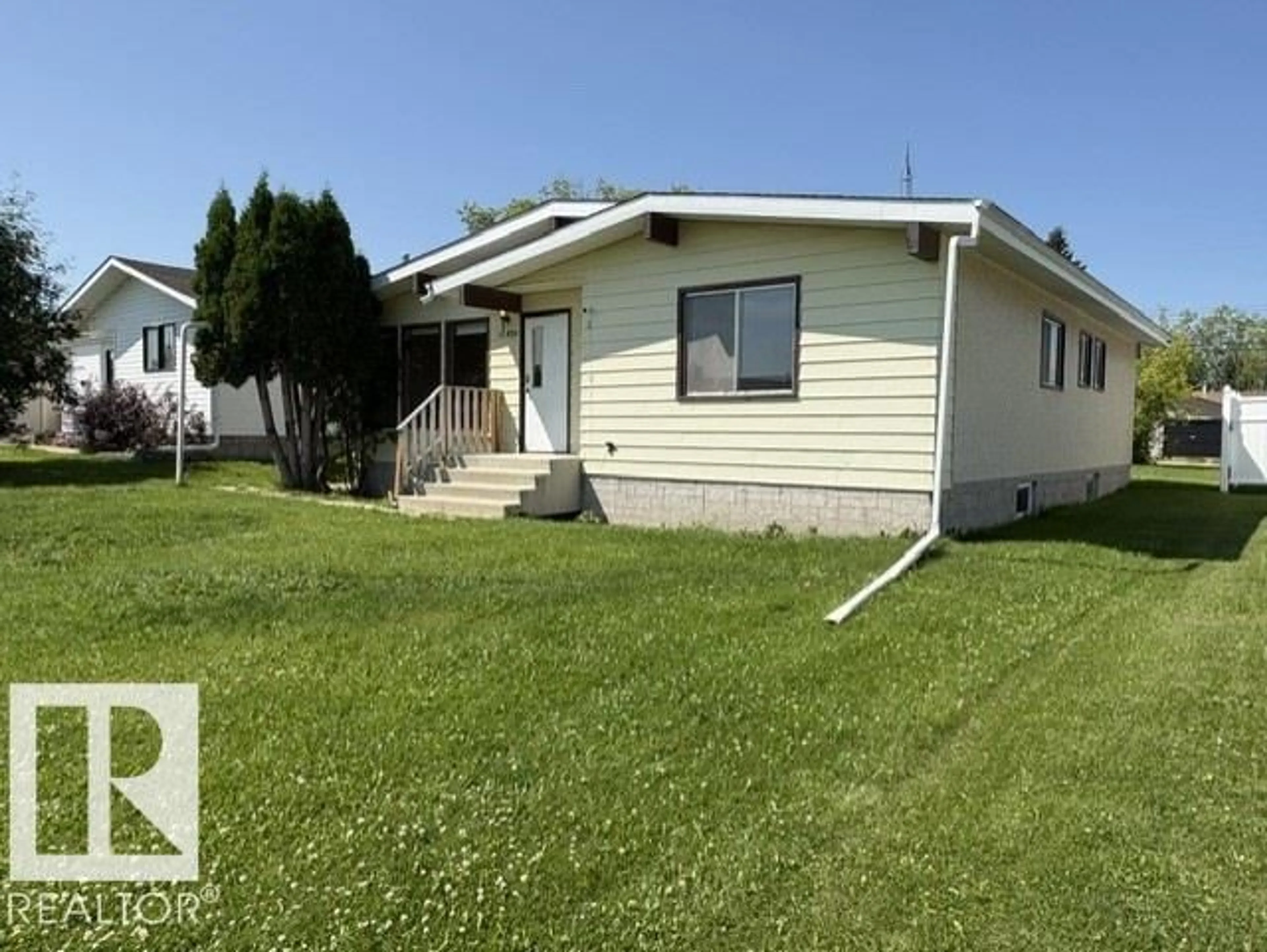 Home with vinyl exterior material, street for 10320 109 AV, Westlock Alberta T7P1B9