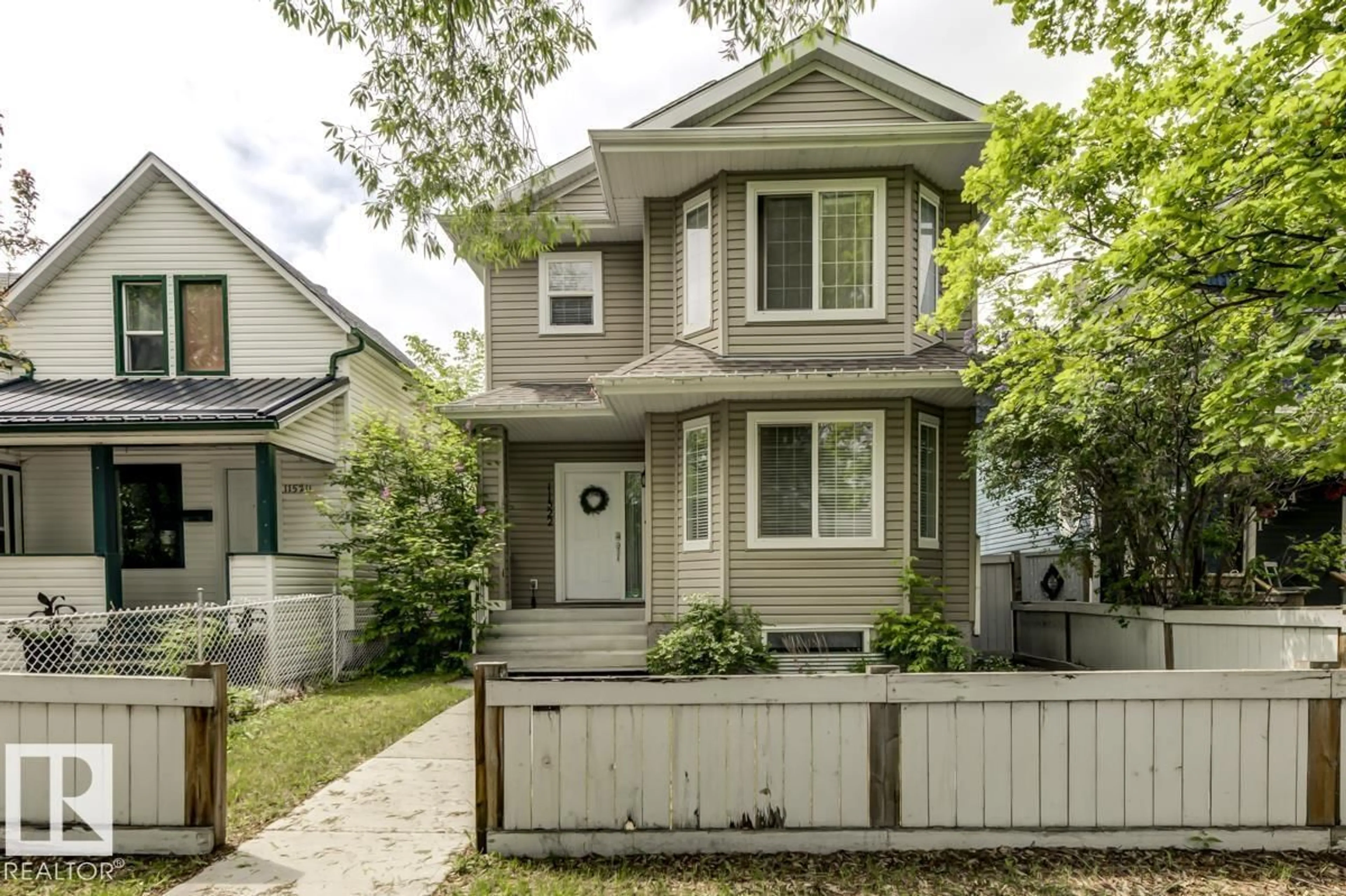 Home with vinyl exterior material, street for NW - 11522 93 ST, Edmonton Alberta T5C0Z2