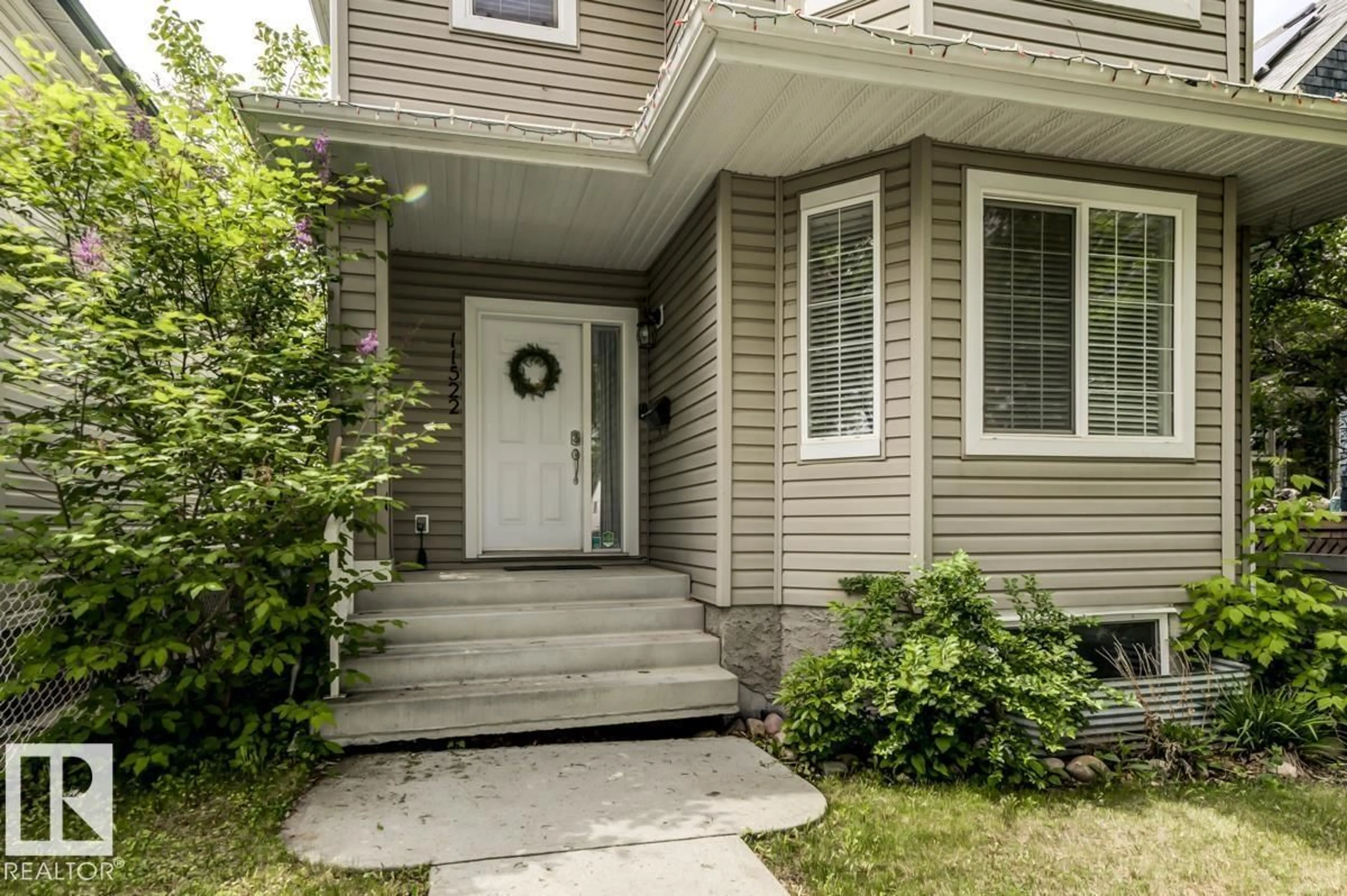 Home with vinyl exterior material, street for NW - 11522 93 ST, Edmonton Alberta T5C0Z2