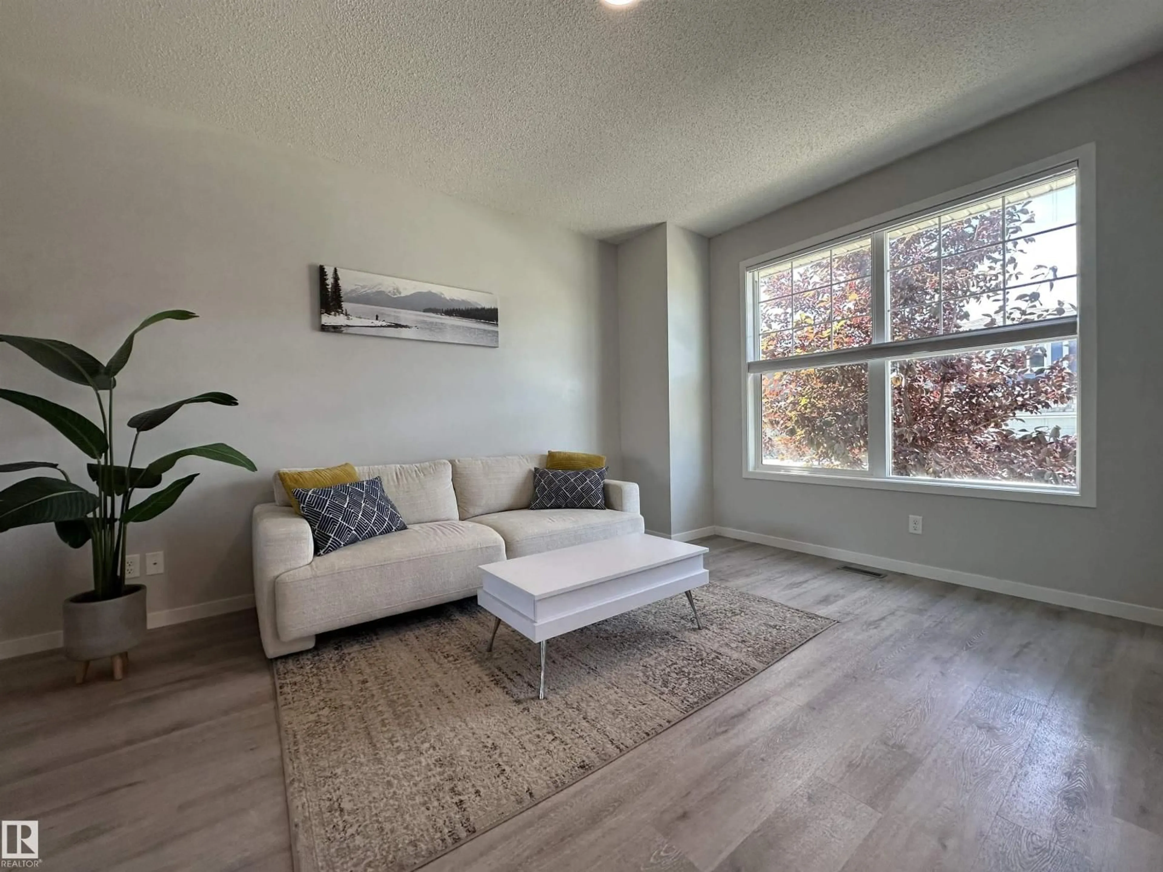 Living room with furniture, wood/laminate floor for SW - 2035 160 ST, Edmonton Alberta T6W4E7