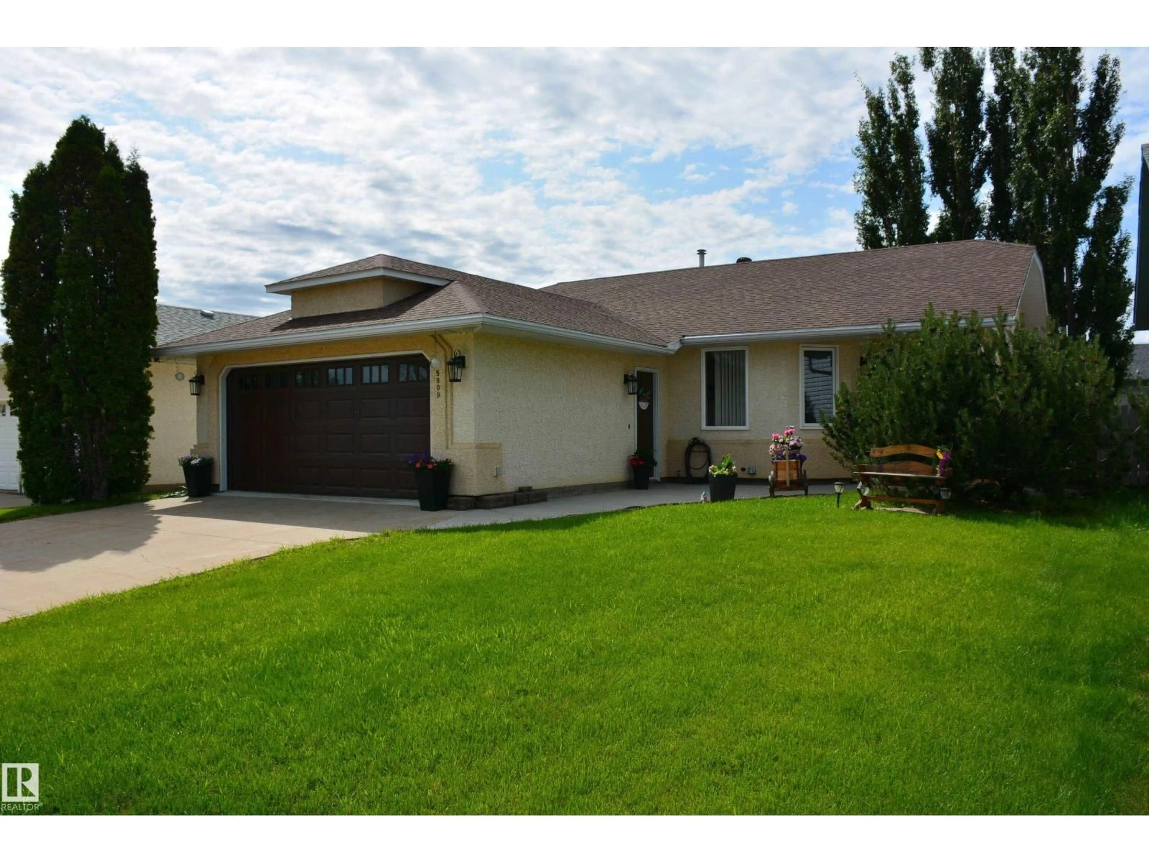 Home with vinyl exterior material, street for 5909 52 AV, Barrhead Alberta T7N1N6