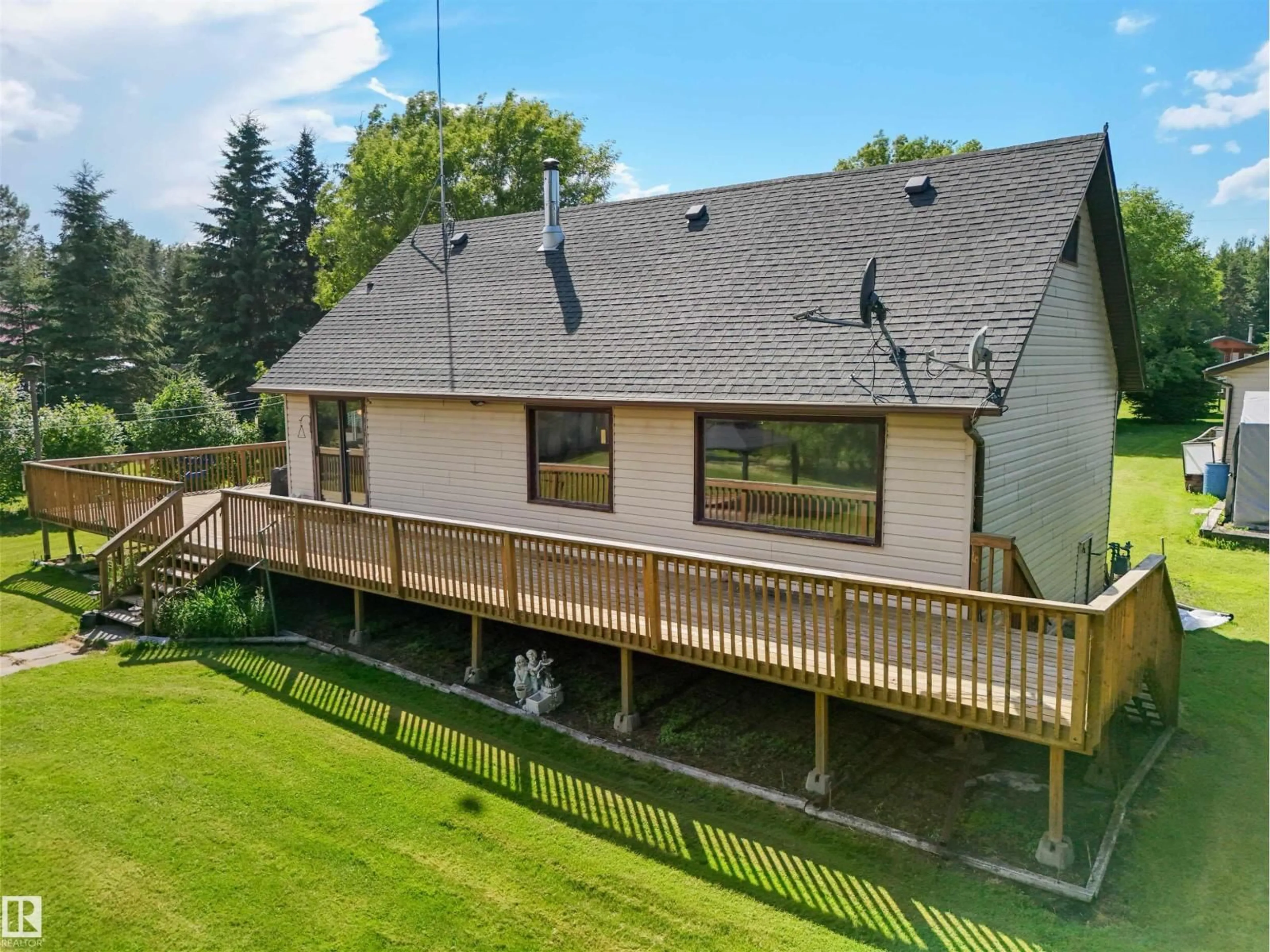 A pic from outside/outdoor area/front of a property/back of a property/a pic from drone, water/lake/river/ocean view for 43 62045 TWP ROAD 462, Rural Wetaskiwin County Alberta T0C0T0