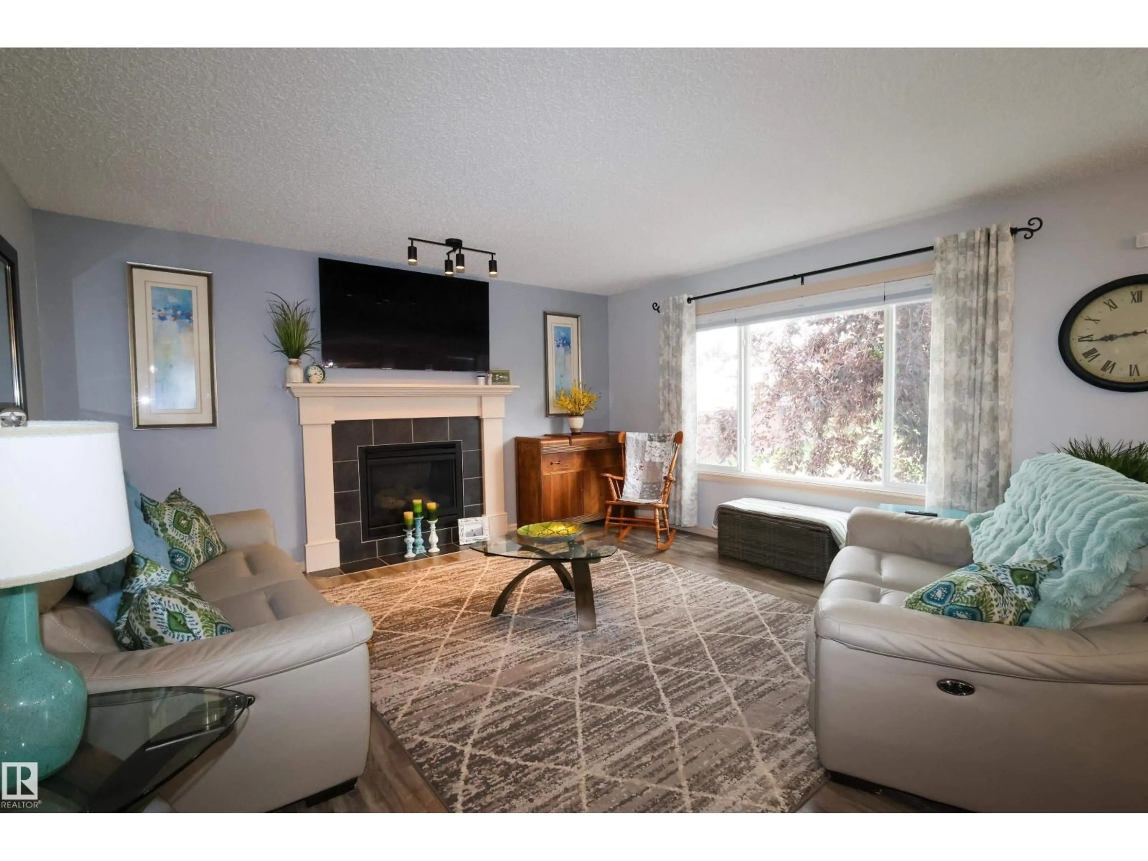 Living room with furniture, wood/laminate floor for 10302 98 ST, Morinville Alberta T8R0B7