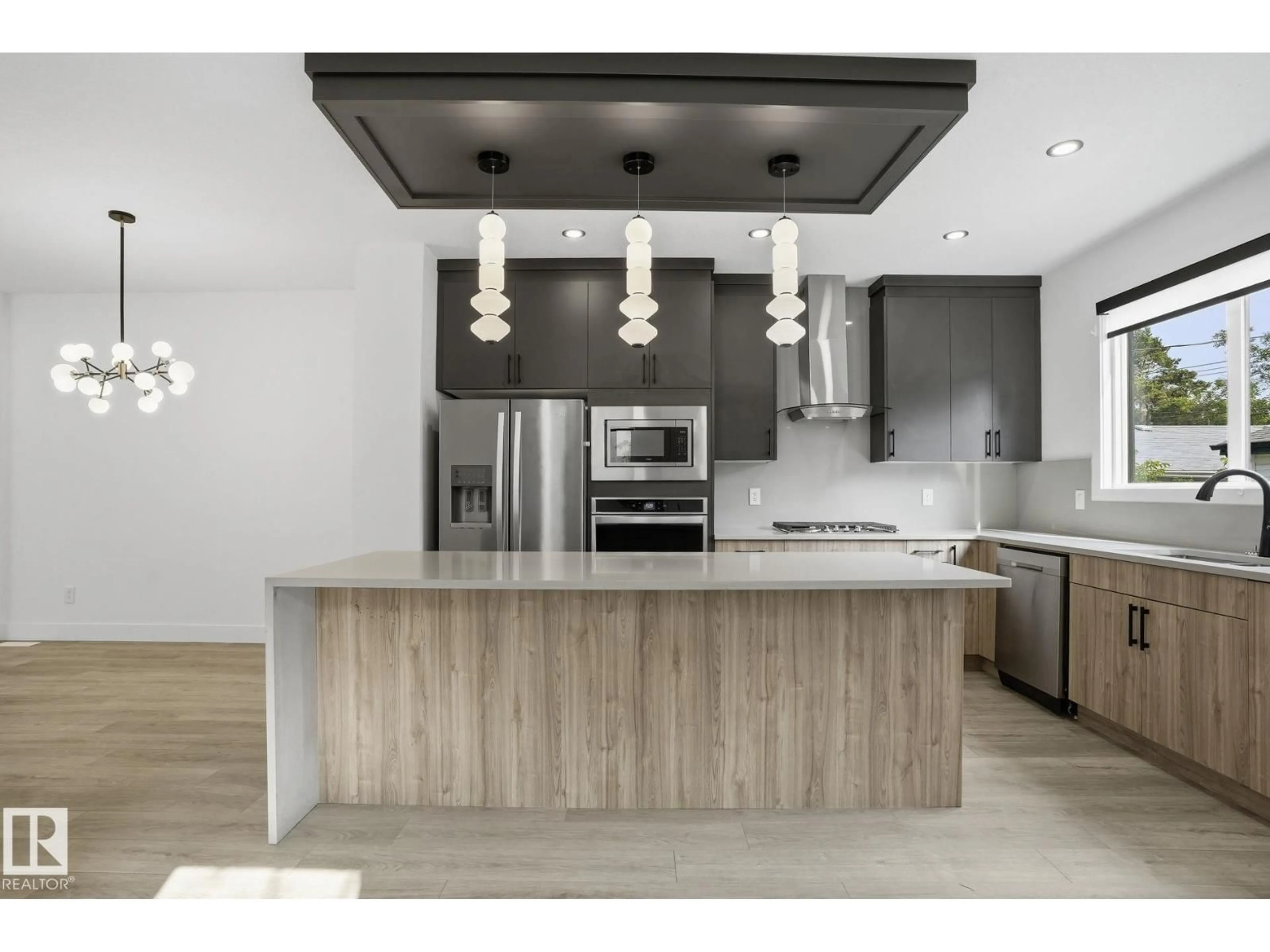 Open concept kitchen, wood/laminate floor for 13909 107A AV, Edmonton Alberta T5M2A8