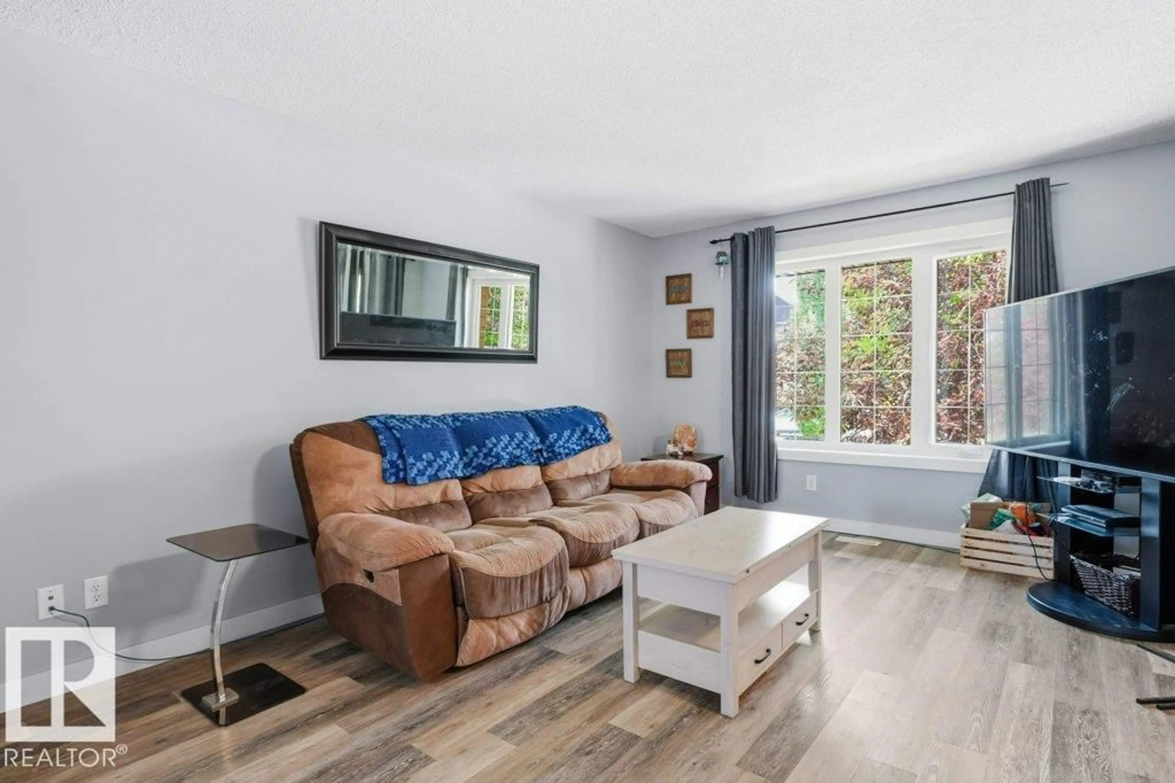 Living room with furniture, wood/laminate floor for 79 TONEWOOD BV, Spruce Grove Alberta T7X0W4