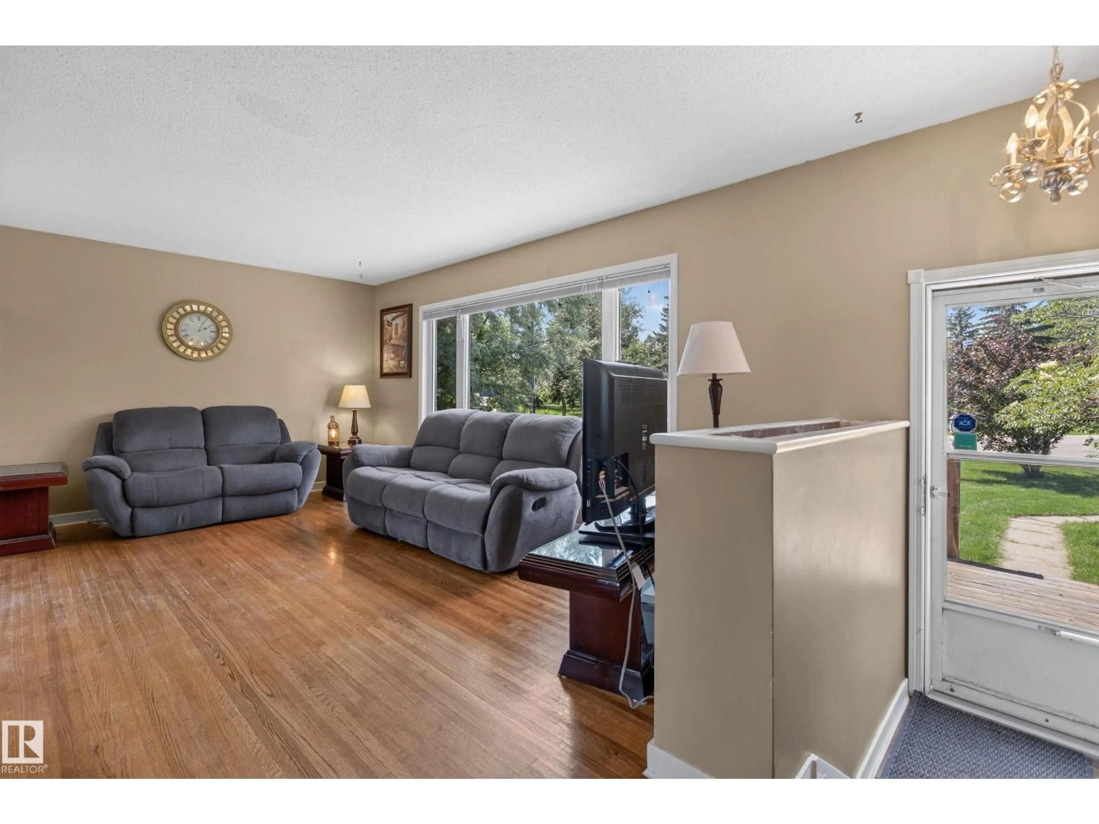 Living room with furniture, wood/laminate floor for 11303 115 ST NW, Edmonton Alberta T5G2V5