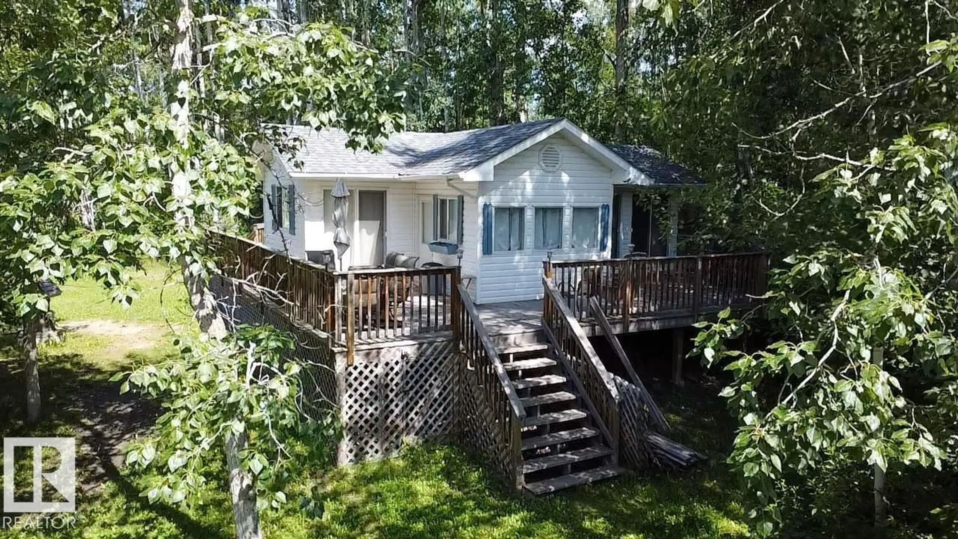 A pic from outside/outdoor area/front of a property/back of a property/a pic from drone, water/lake/river/ocean view for 55107 - 707 RGE ROAD 33, Rural Lac Ste. Anne County Alberta T0E1A0