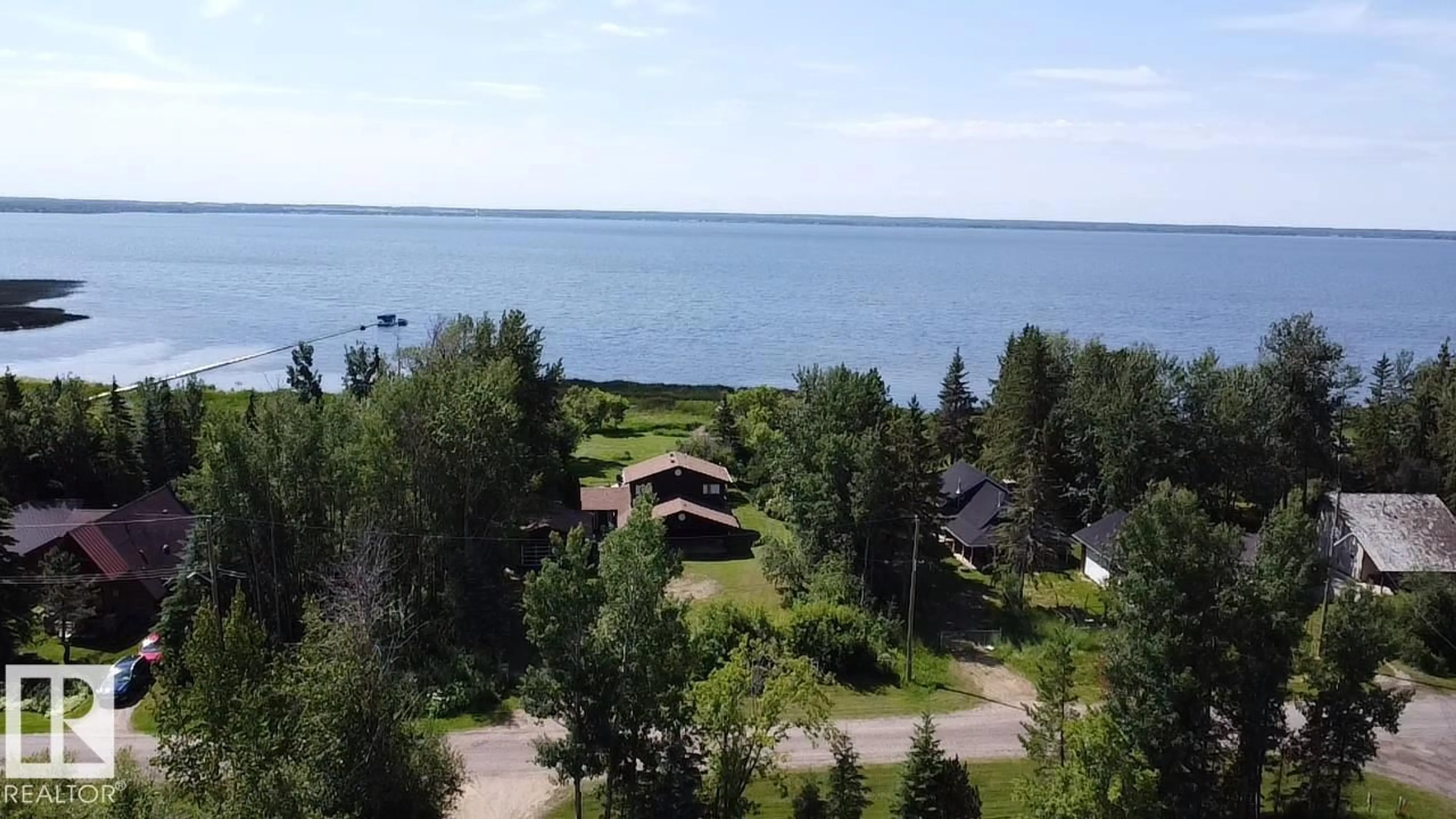 A pic from outside/outdoor area/front of a property/back of a property/a pic from drone, water/lake/river/ocean view for 55107 - 707 RGE ROAD 33, Rural Lac Ste. Anne County Alberta T0E1A0