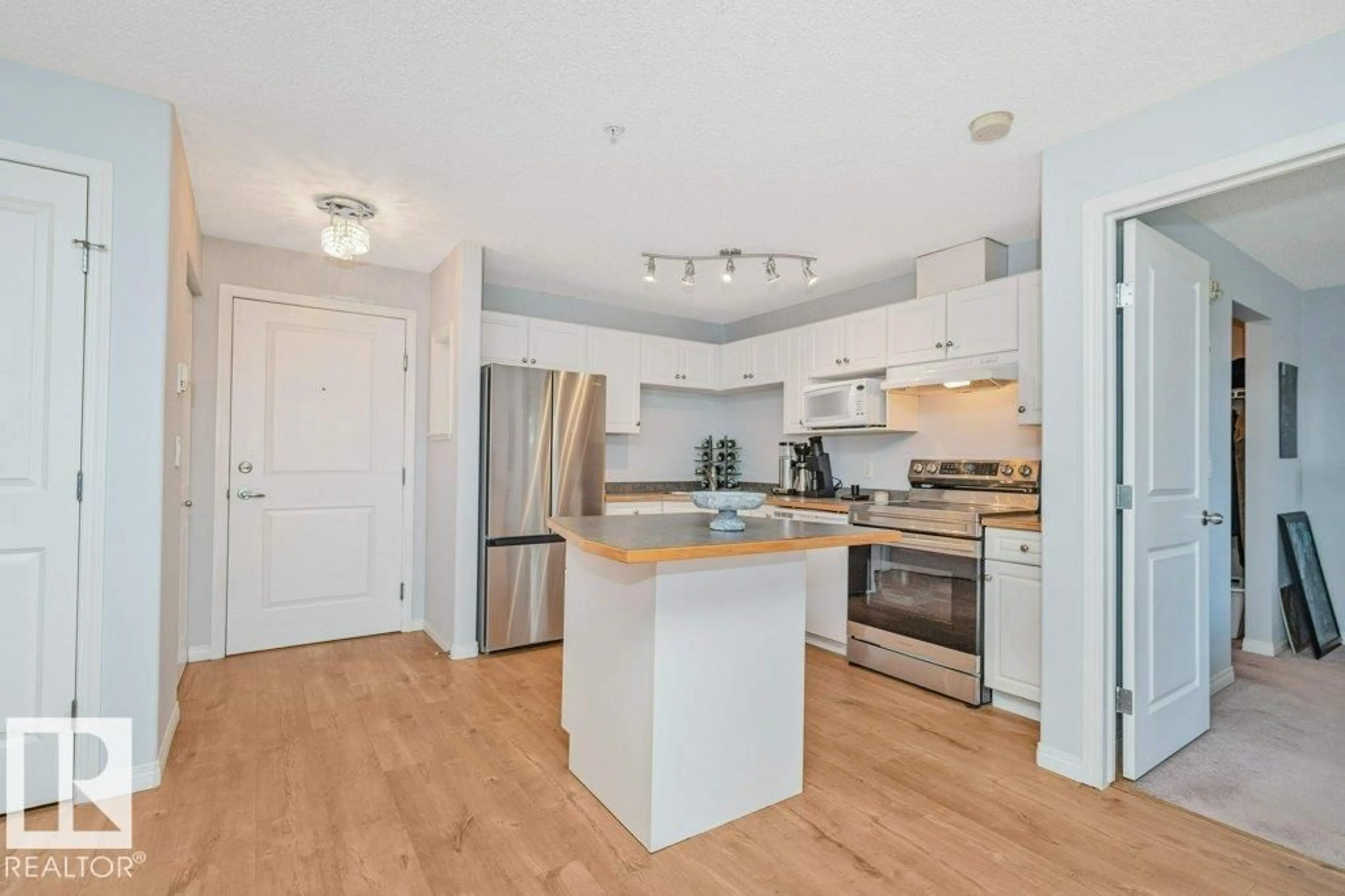 Open concept kitchen, wood/laminate floor for 217 - 245 EDWARDS DR, Edmonton Alberta T6X1J9