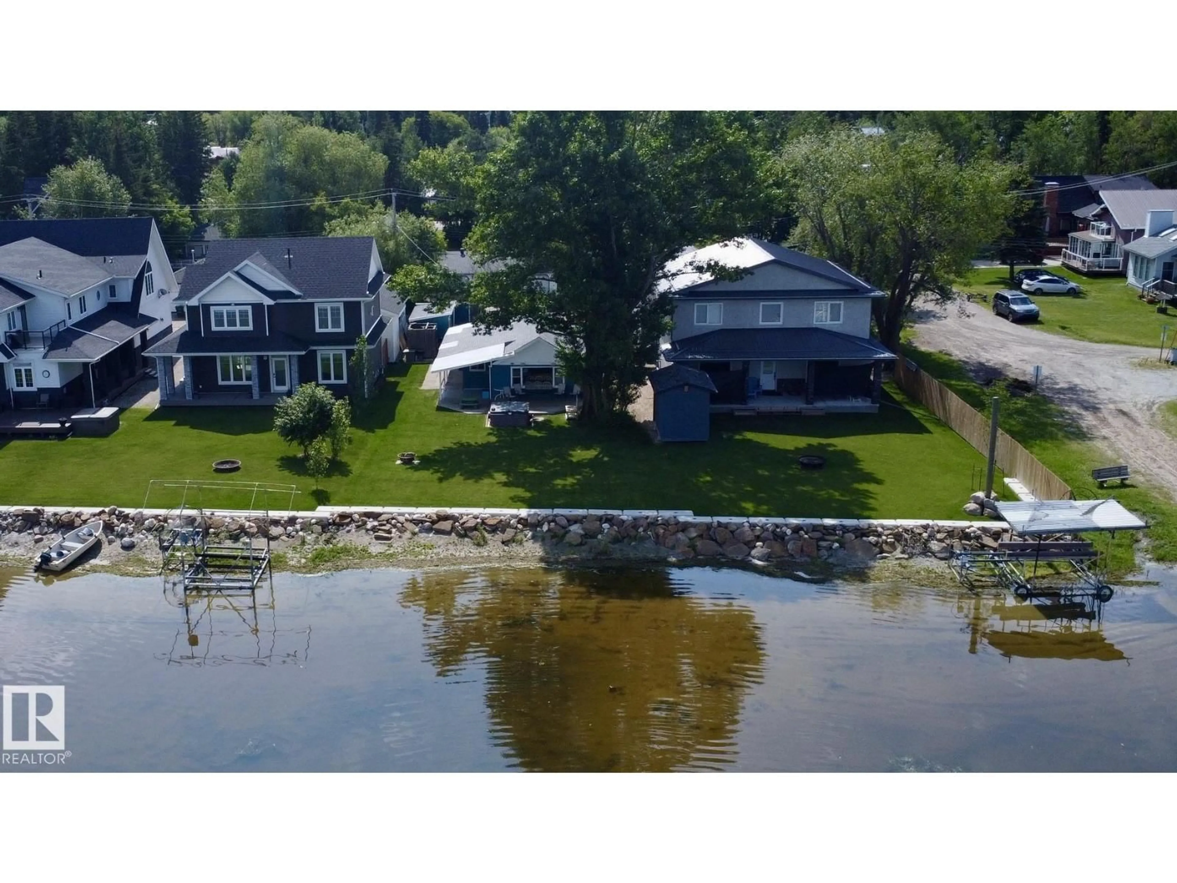 A pic from outside/outdoor area/front of a property/back of a property/a pic from drone, water/lake/river/ocean view for 5227 51 AV, Rural Lac Ste. Anne County Alberta T9X1T7