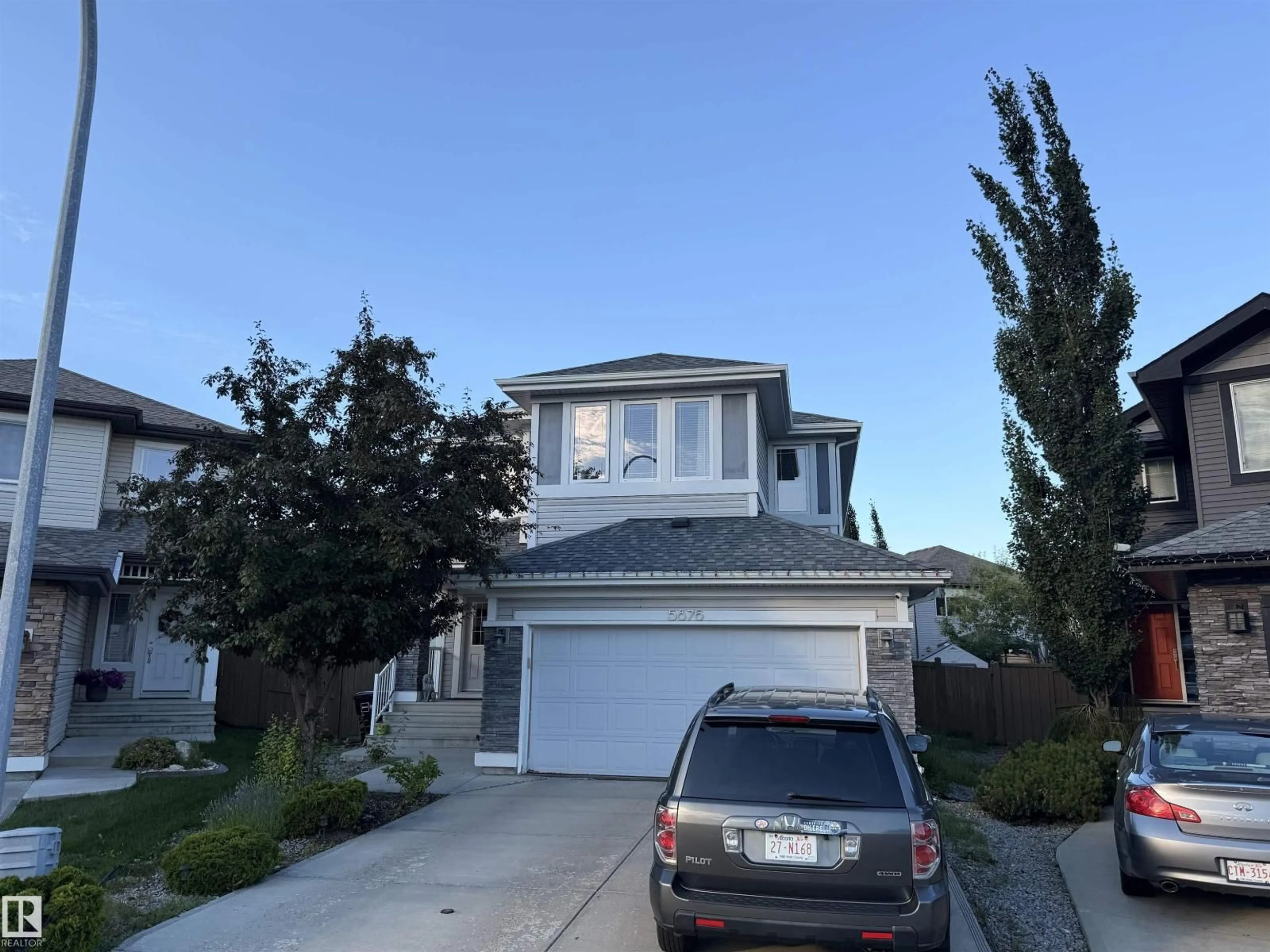 Home with vinyl exterior material, street for 5876 168 AV, Edmonton Alberta T5Y0N2