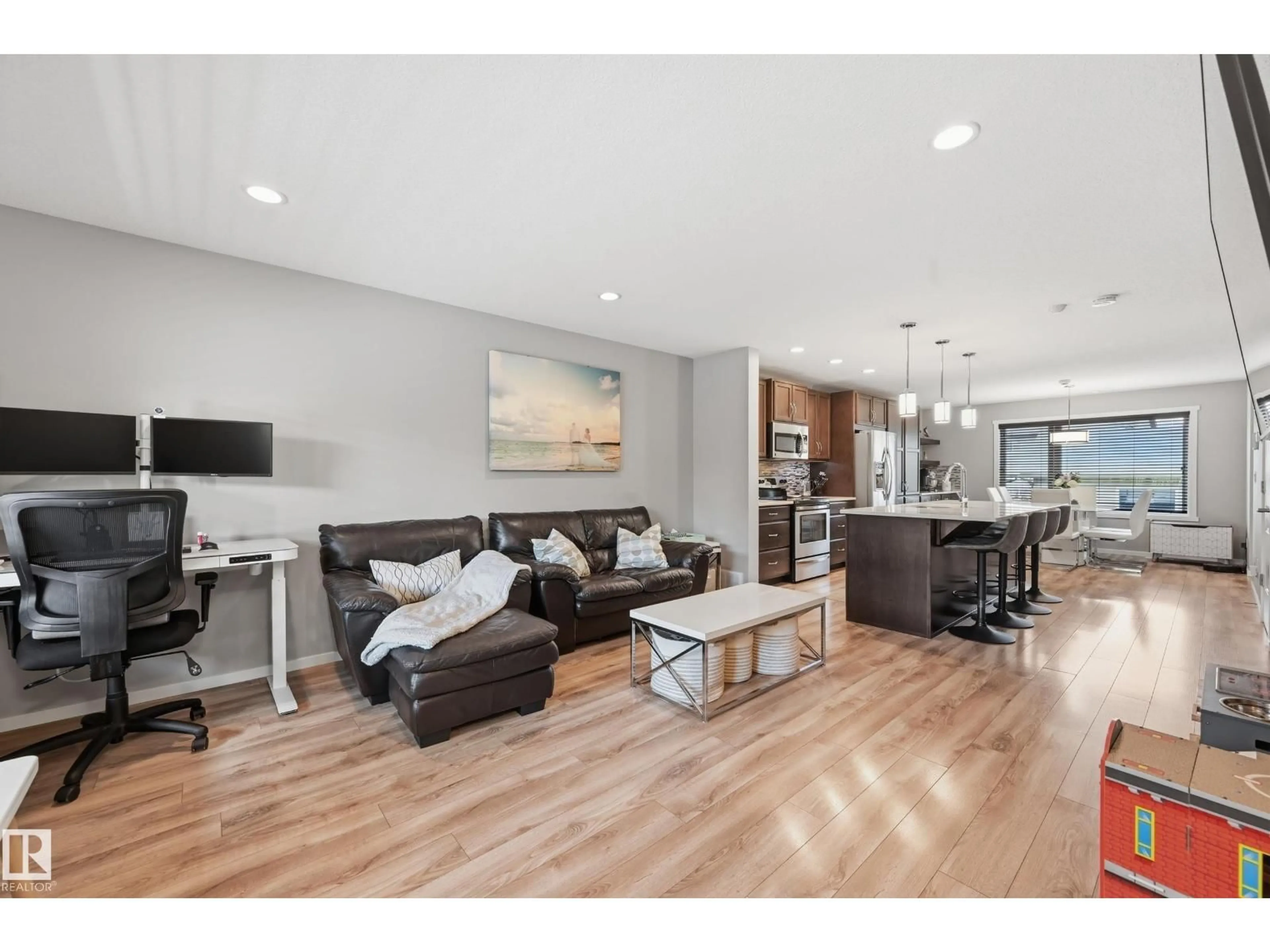 Living room with furniture, wood/laminate floor for 3457 CUTLER CR, Edmonton Alberta T6W2B3