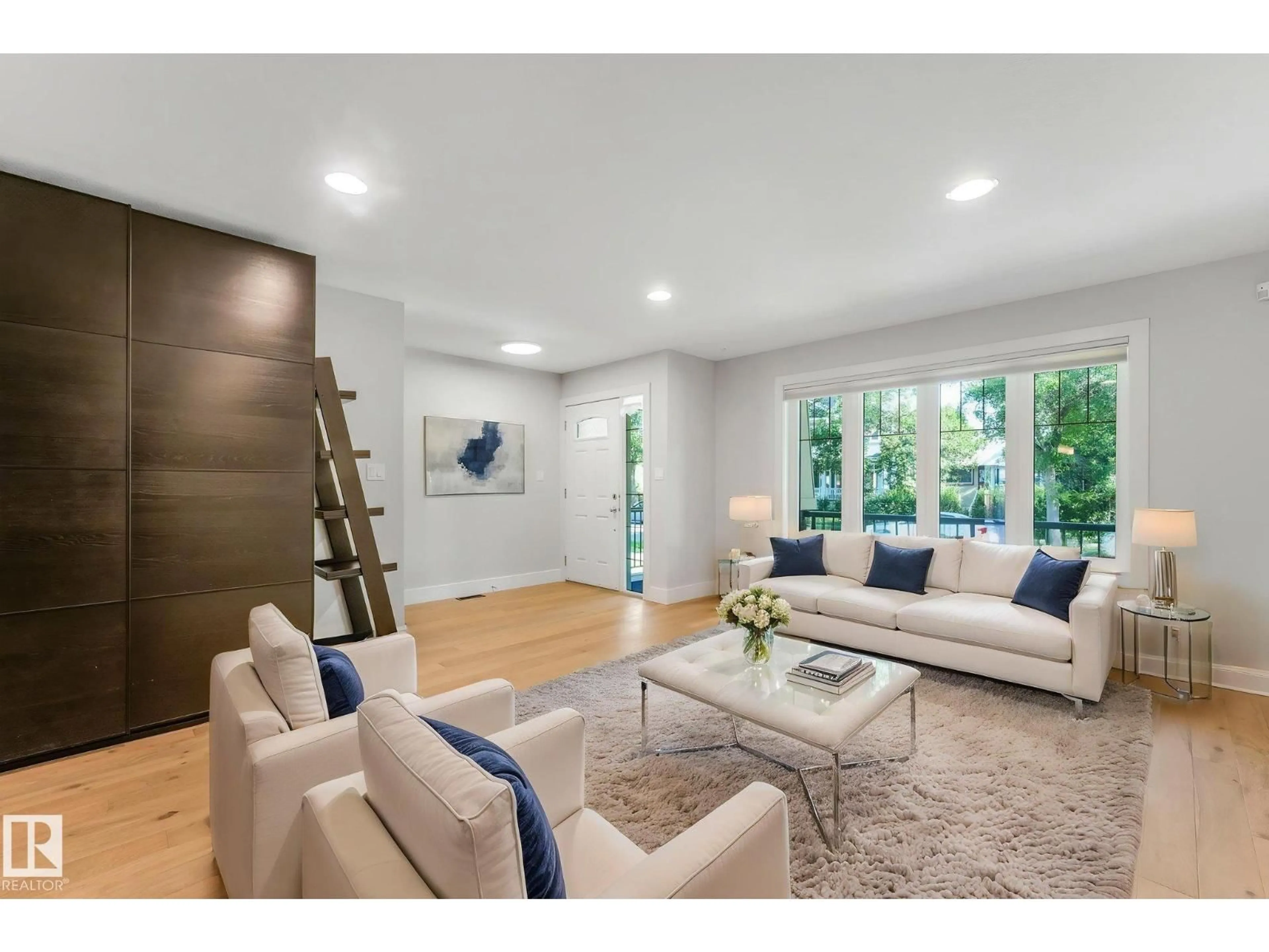 Living room with furniture, wood/laminate floor for 10433 70 AV, Edmonton Alberta T6H2E7