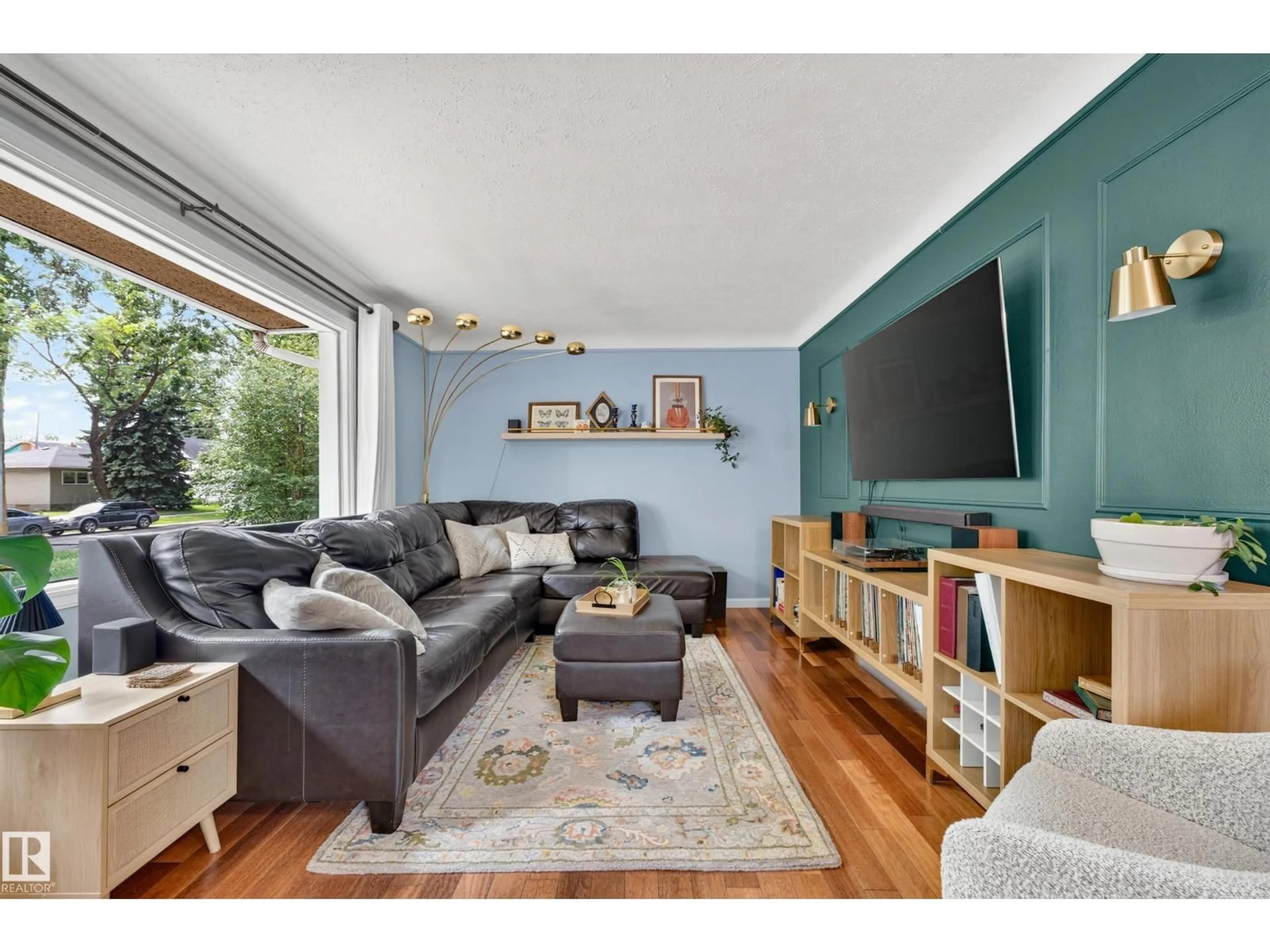 Living room with furniture, wood/laminate floor for NW - 7530 80 AV, Edmonton Alberta T6C0S4