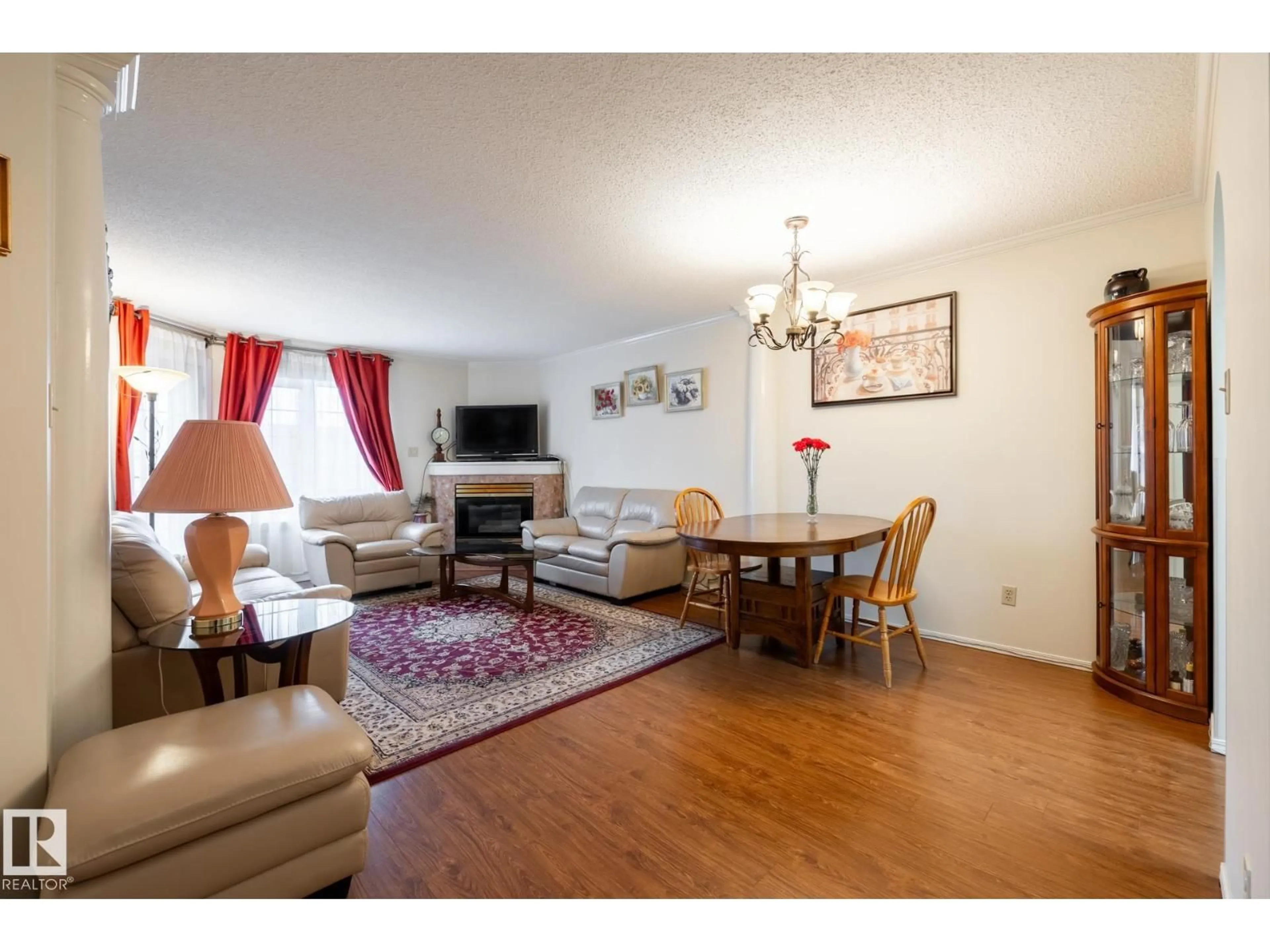 Living room with furniture, wood/laminate floor for 310 - 17151 94A AV, Edmonton Alberta T5T5Z9