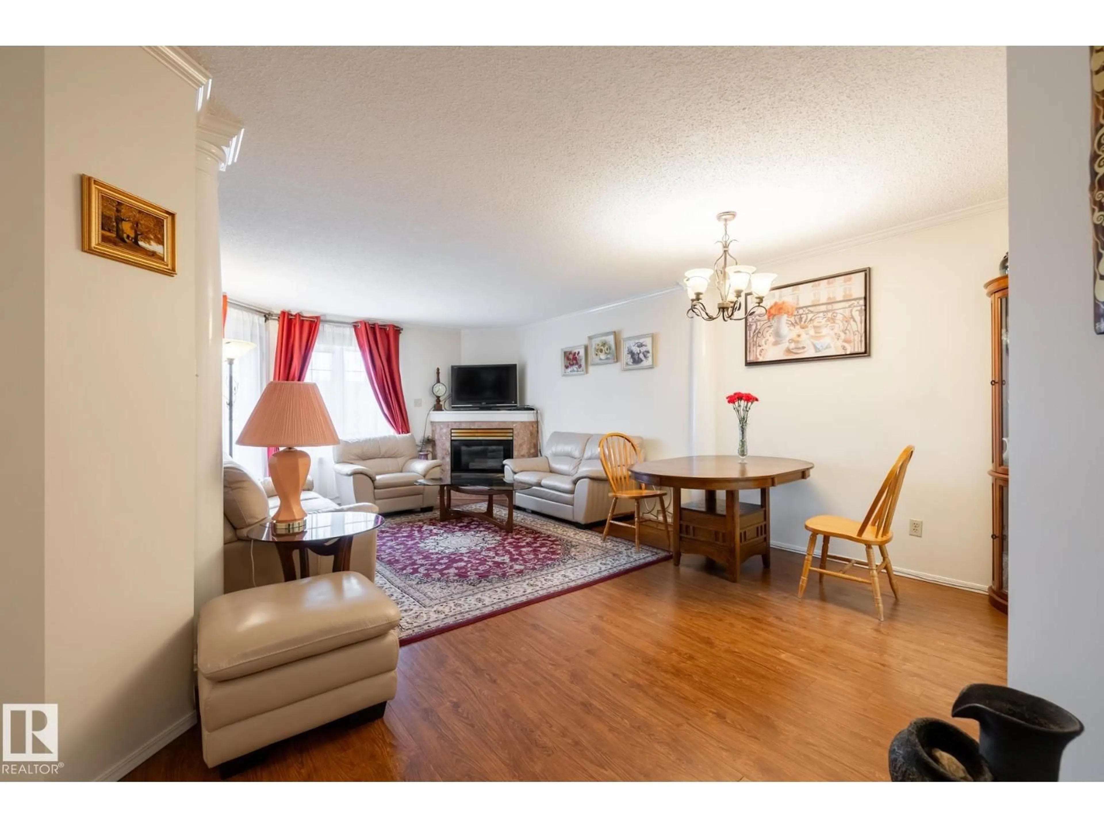 Living room with furniture, wood/laminate floor for 310 - 17151 94A AV, Edmonton Alberta T5T5Z9