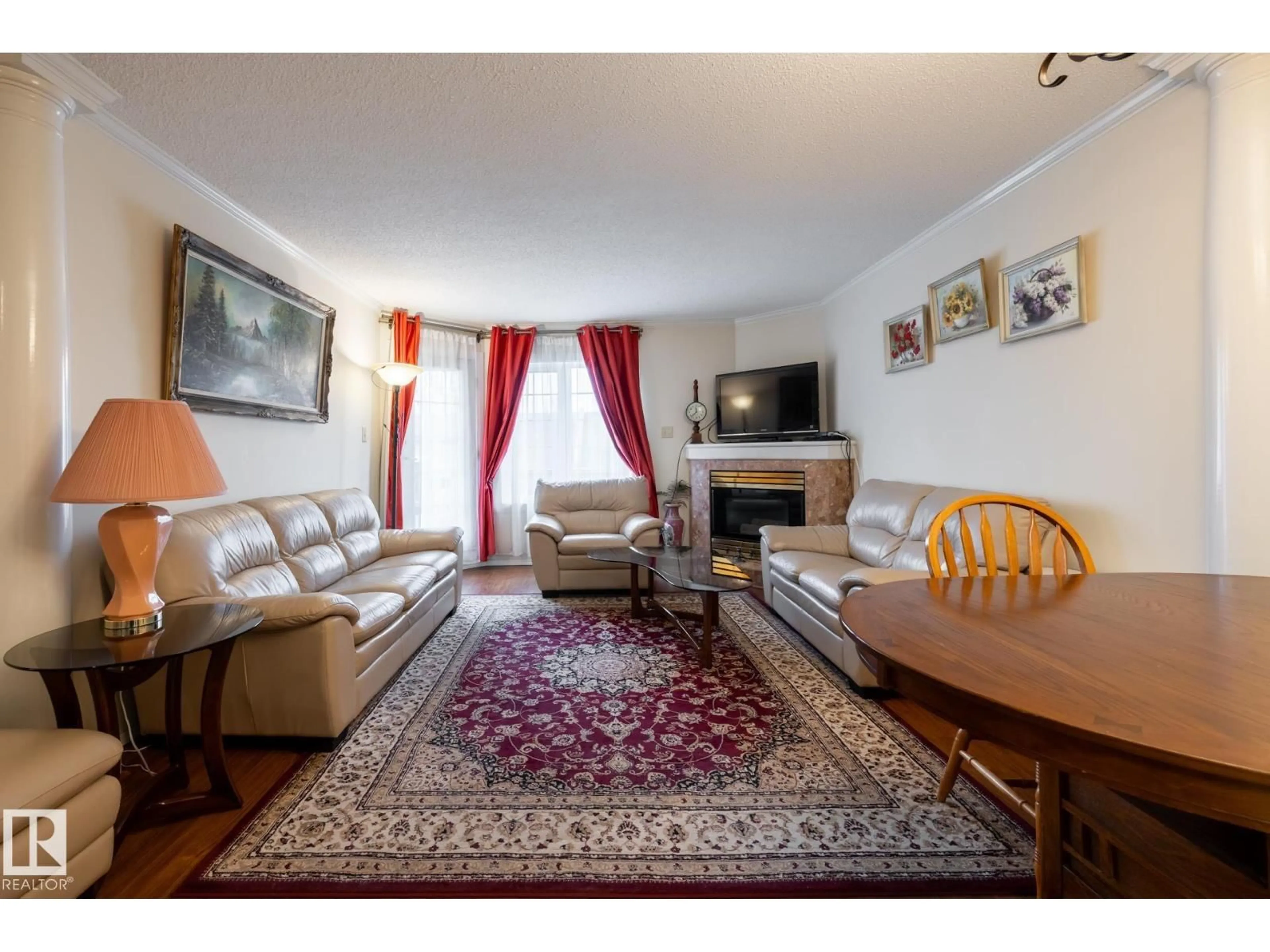 Living room with furniture, wood/laminate floor for 310 - 17151 94A AV, Edmonton Alberta T5T5Z9