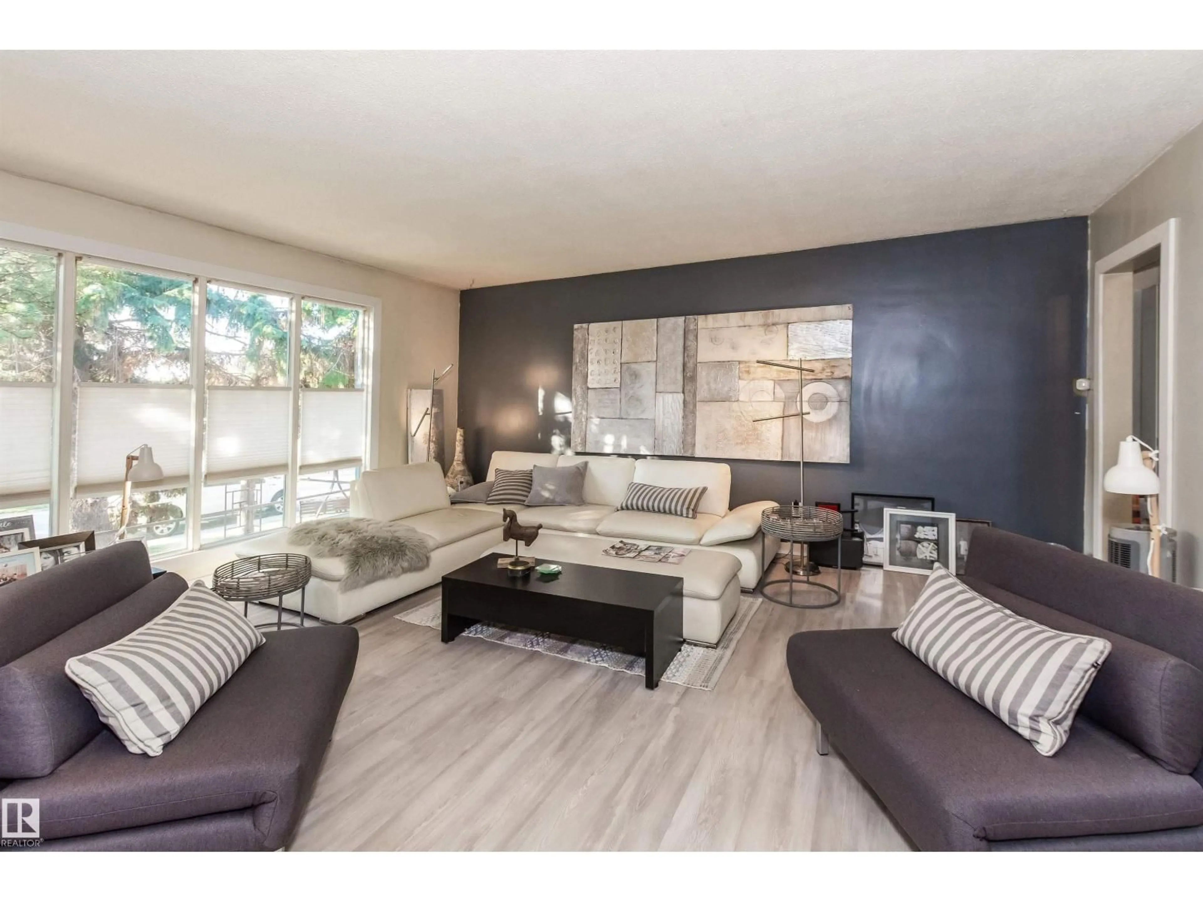 Living room with furniture, wood/laminate floor for NW - 13208 128 AV, Edmonton Alberta T5L3H2