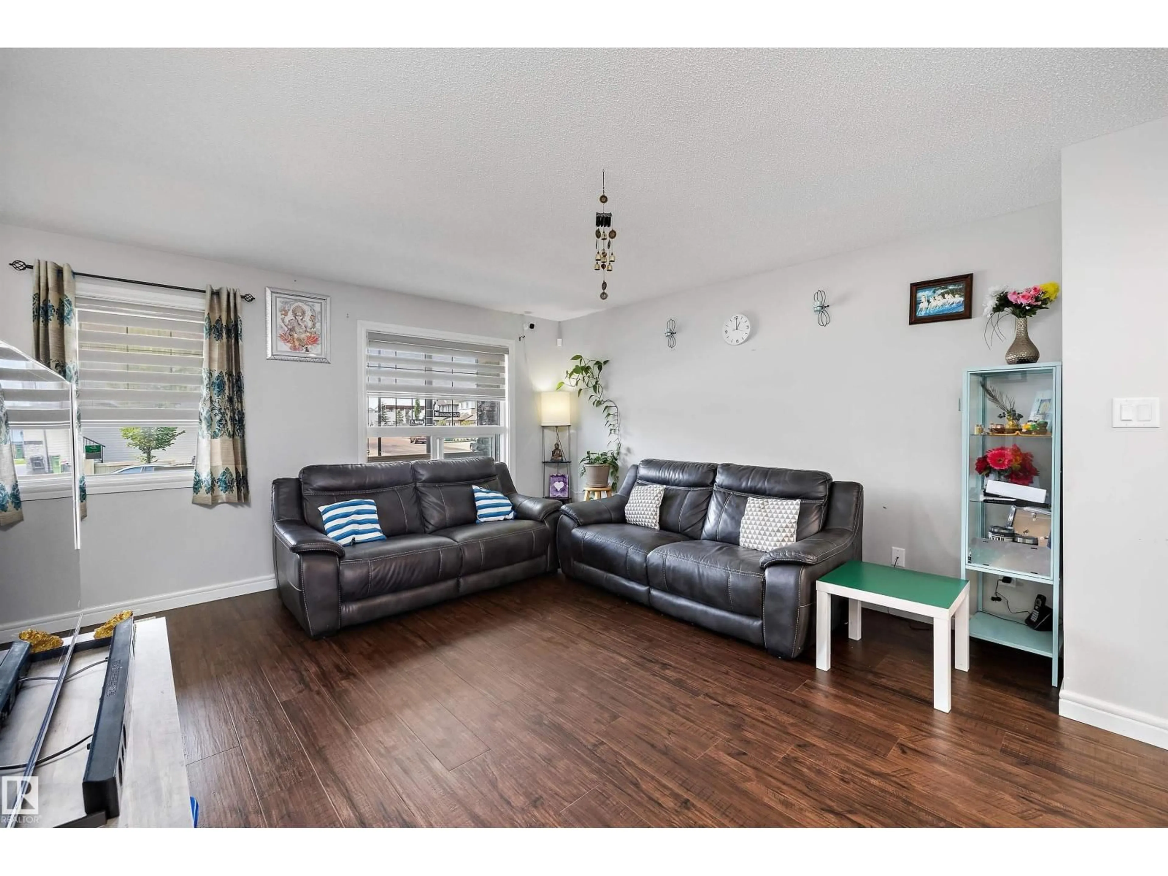 Living room with furniture, wood/laminate floor for 1563 TAMARACK BV, Edmonton Alberta T6T2E2